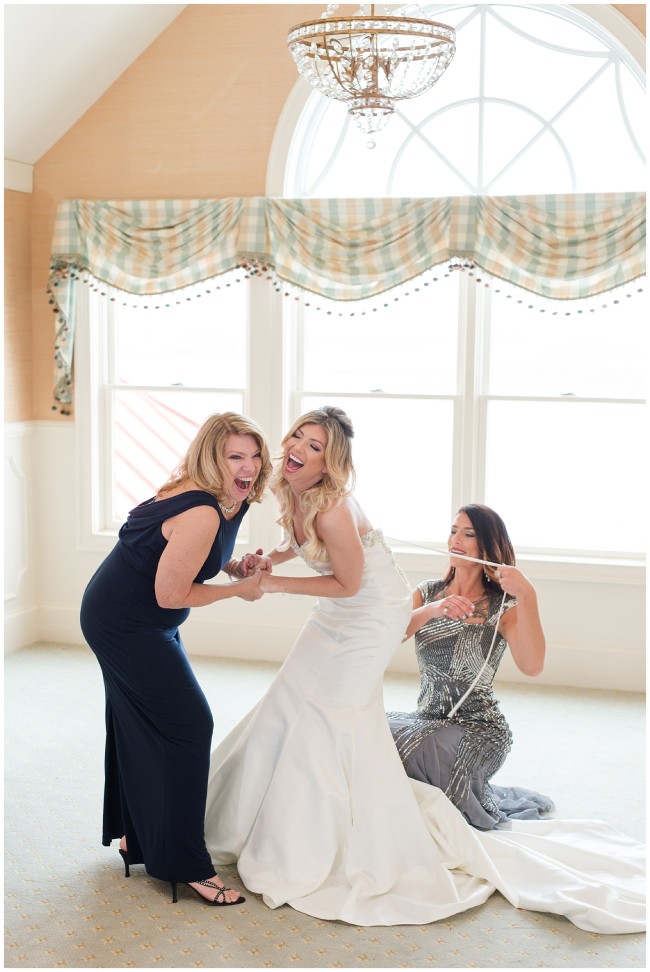bride laughing with her mom on her wedding day
