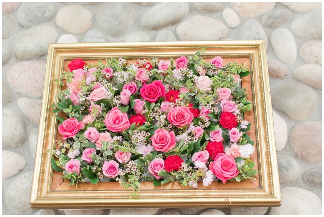 Gorgeous gold picture frame with different shades of pink flowers