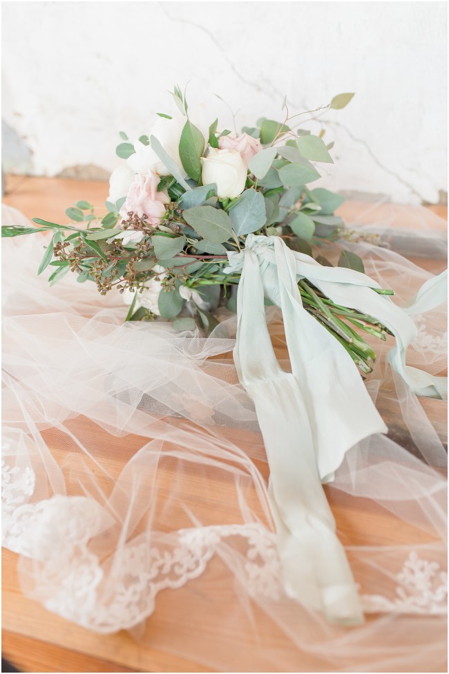 blue silk ribbon tied to wedding bouquet