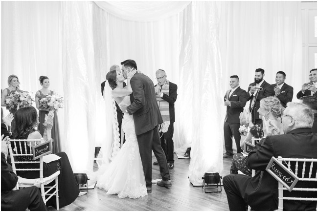 bride and groom kissing at the altar