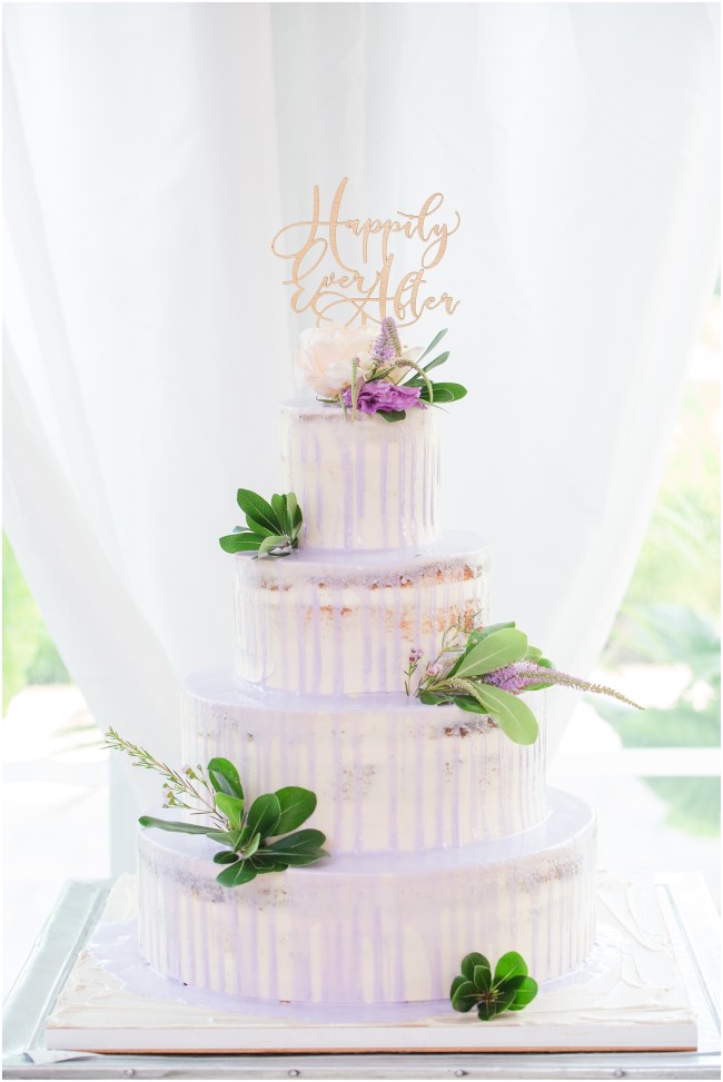 cannoli filled cake with purple drip icing, gold wedding topper
