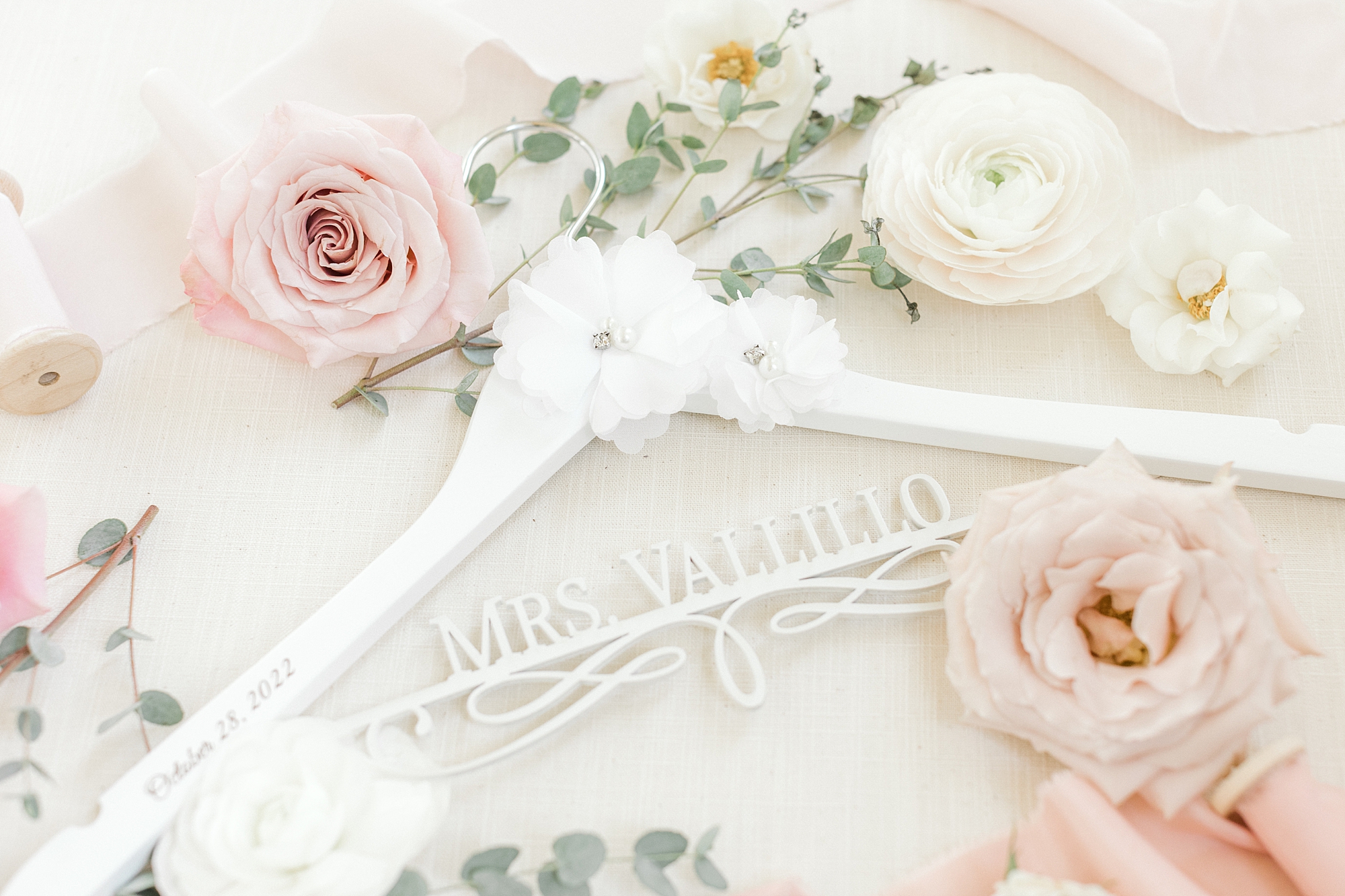 custom hanger for bride's dress with pink and with flowers around it