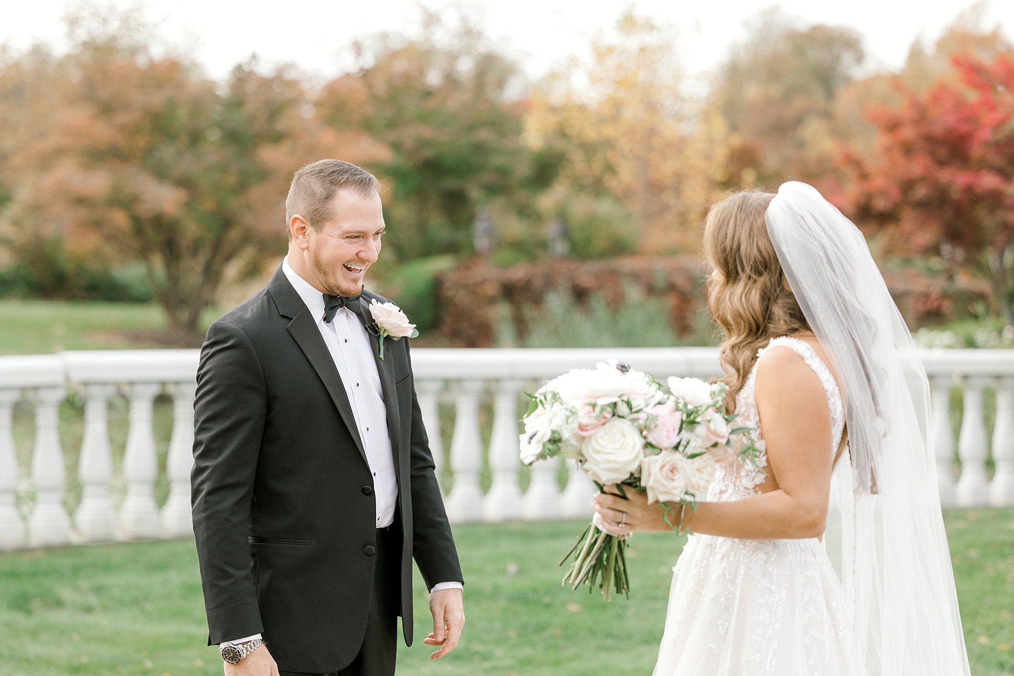 groom admires bride during first look on lawn at the Ashford Estate