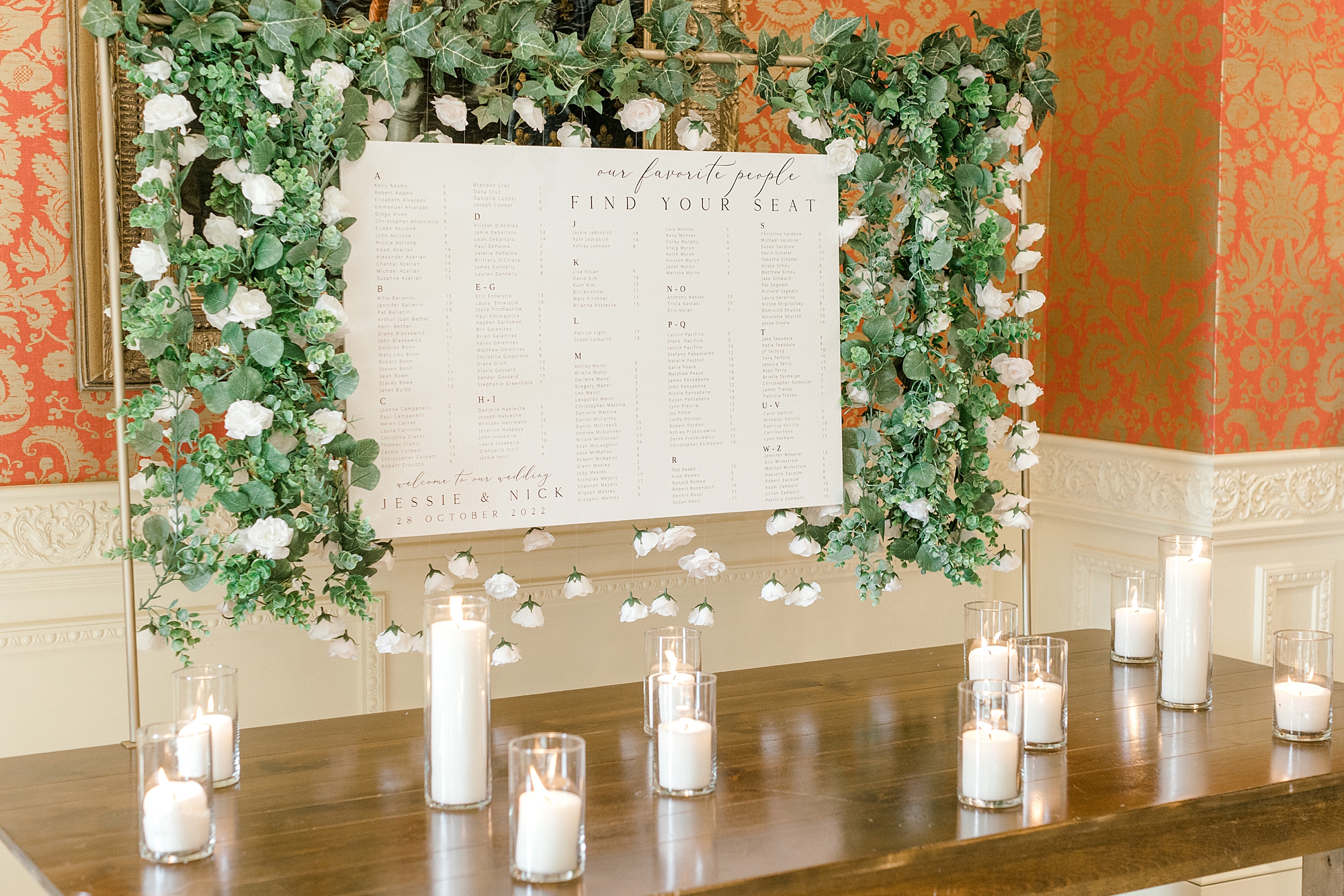 seating chart on large paper with greenery draped around edges