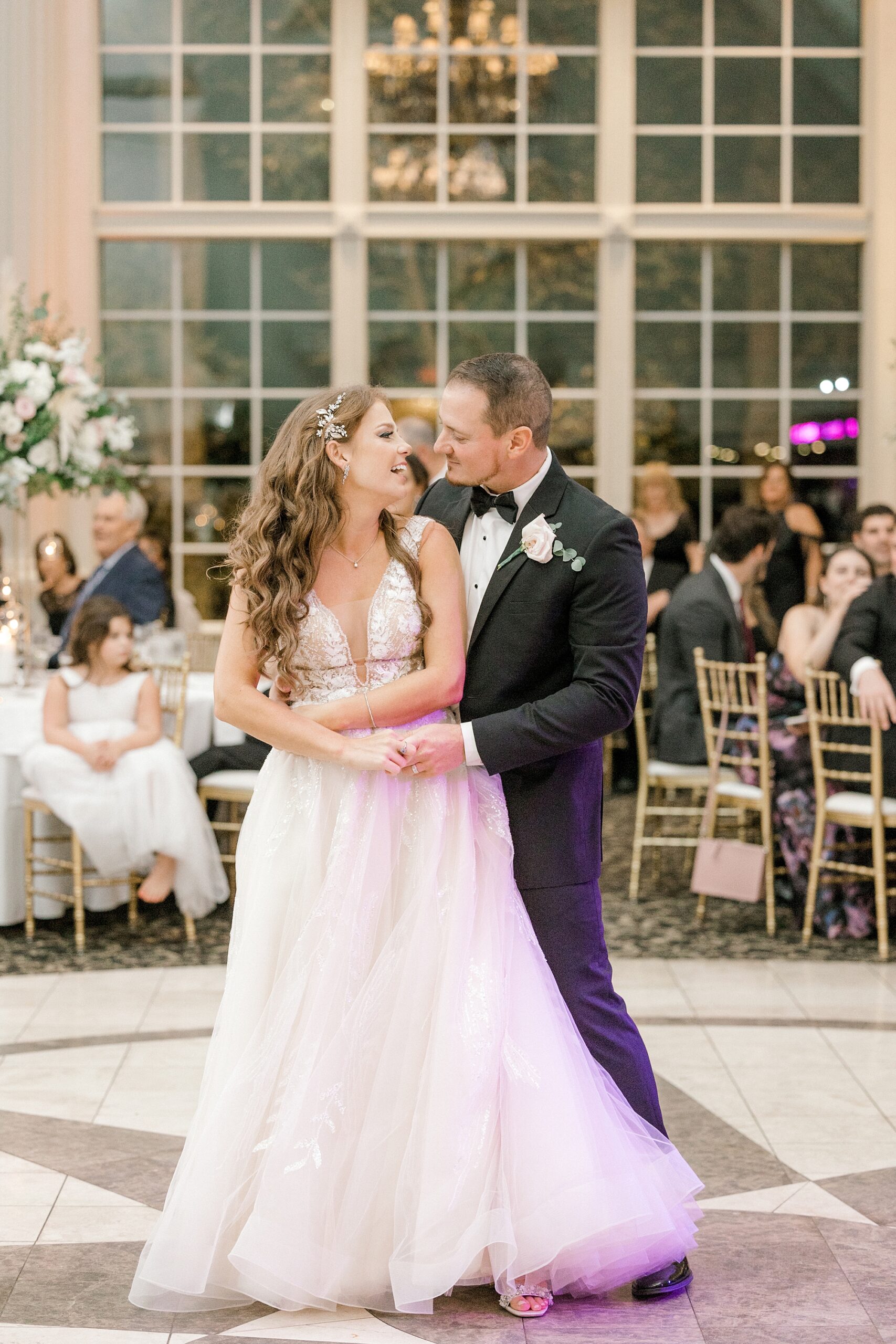 groom twirls bride into his arms during first dance