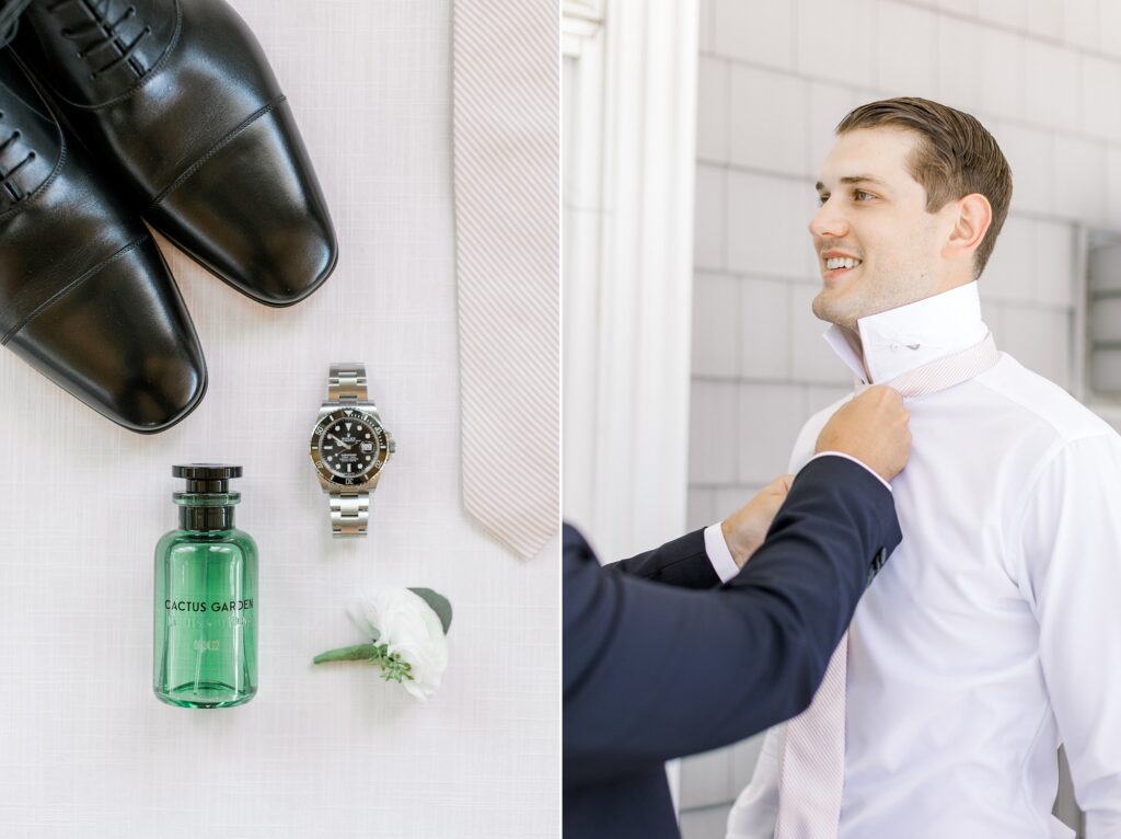 groomsman in navy suit jacket helps groom with buttons 