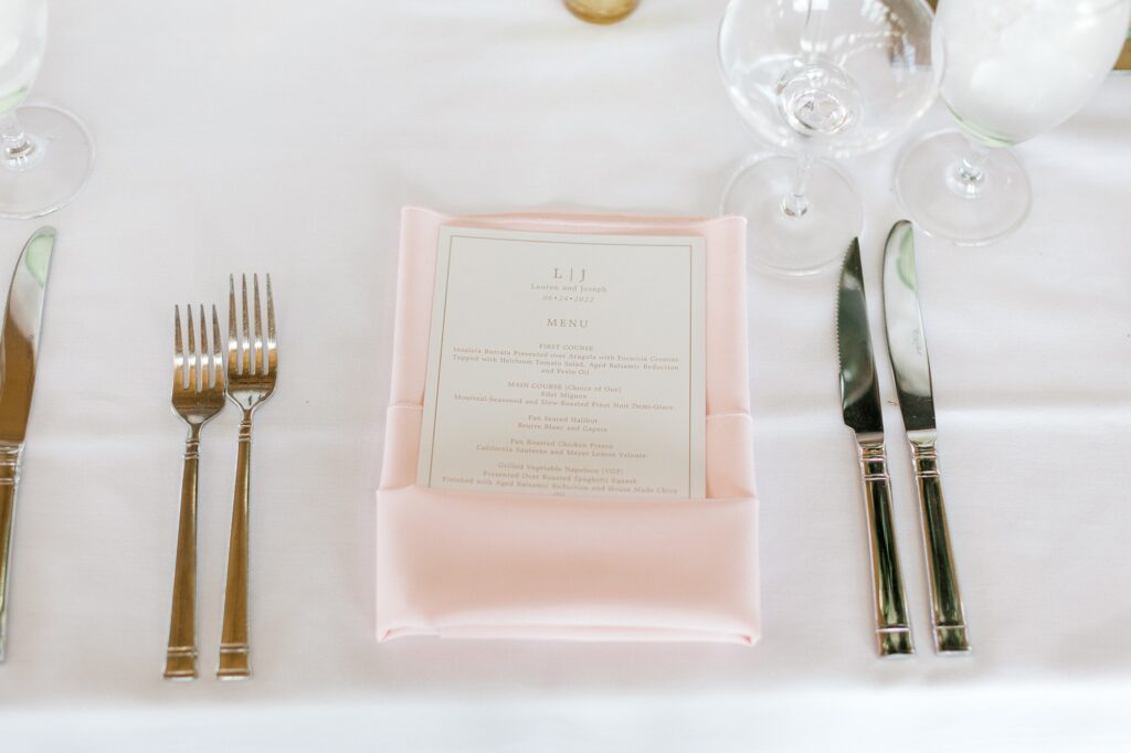 place setting with pink napkin holding menu card at Bonnet Island Estate