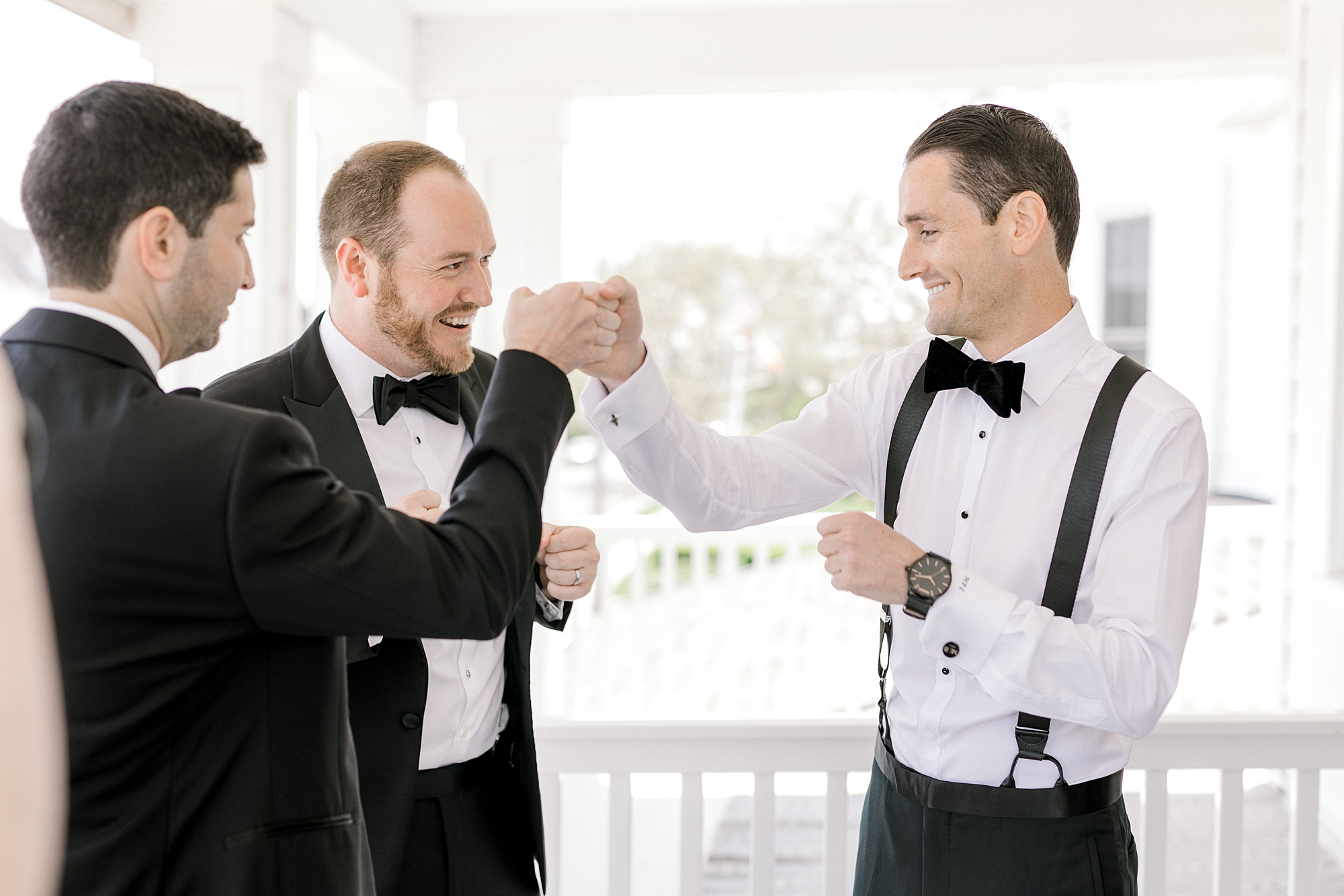 groomsmen toast with groom on front porch of NJ home
