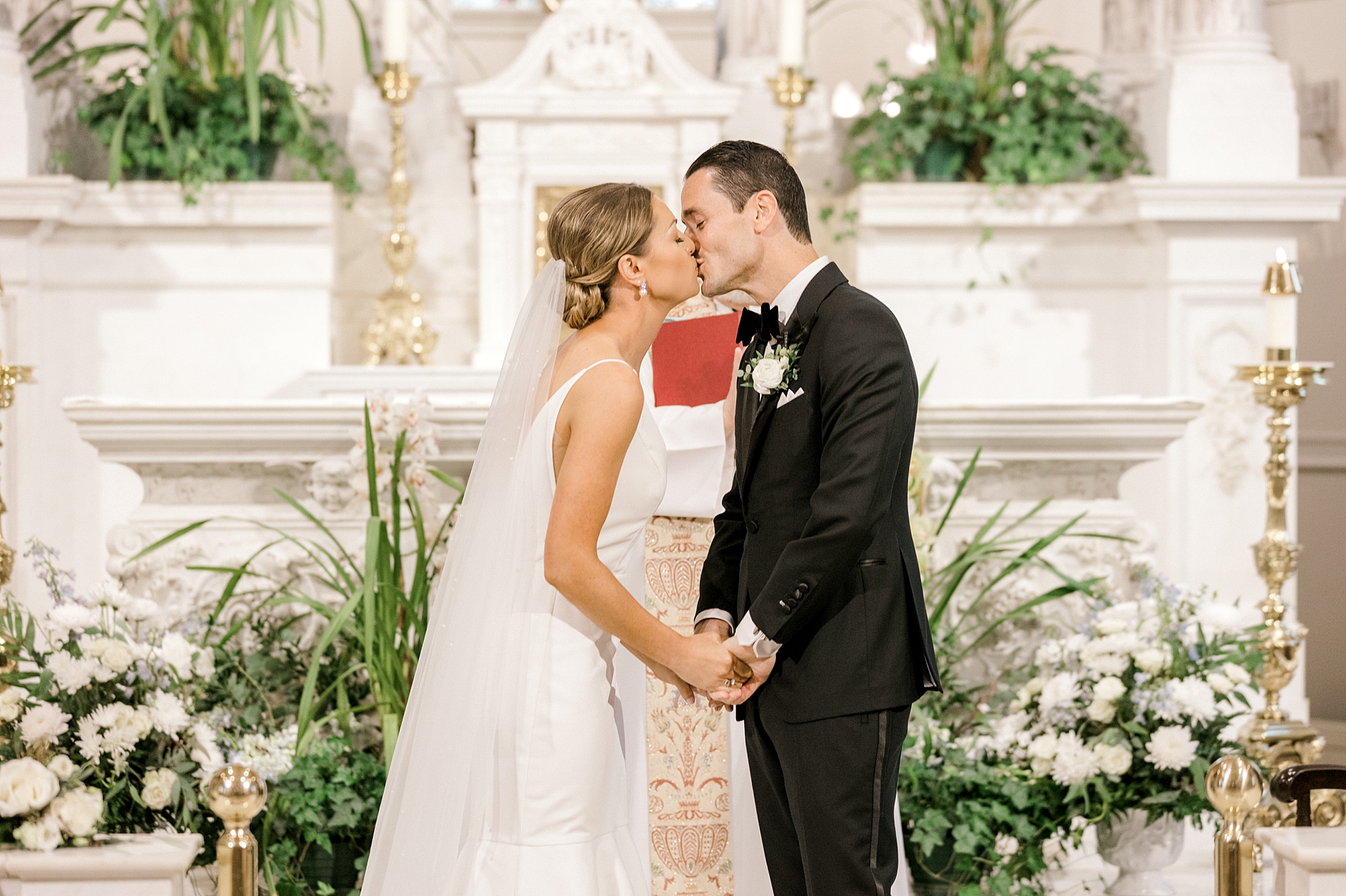bride and groom kiss at alter during church wedding ceremony in New Jersey