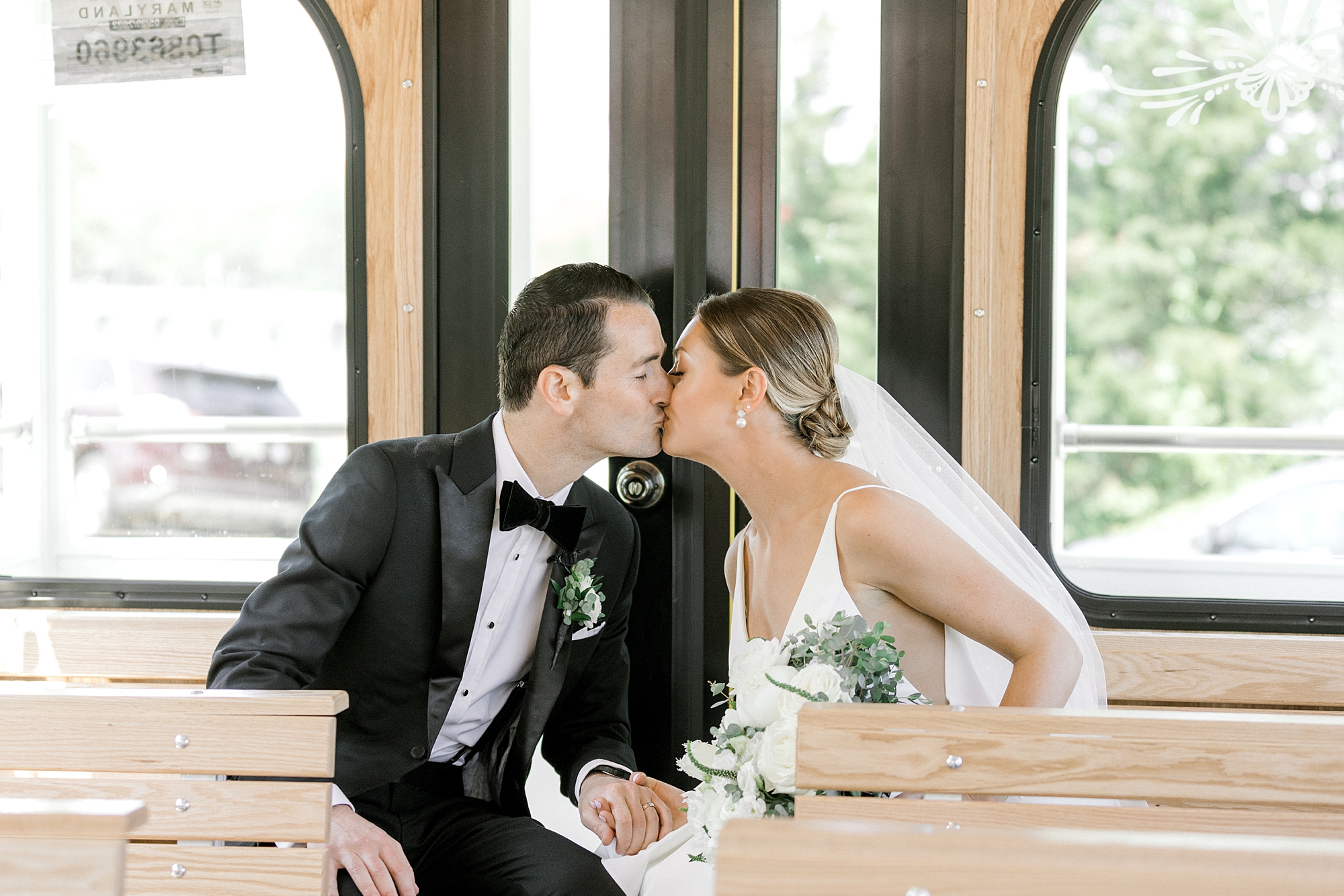 bride and groom kiss on trolley in New Jersey