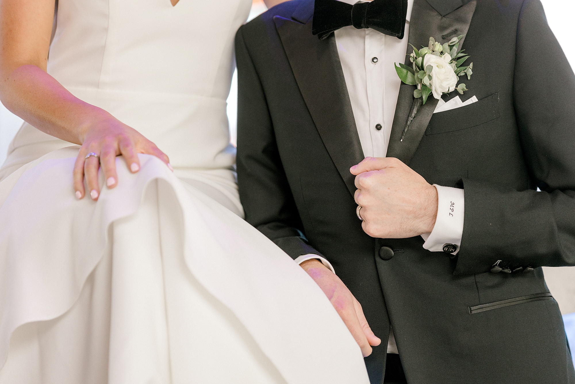 groom leans against bar and bride's skirt at Crystal Point Yacht Club