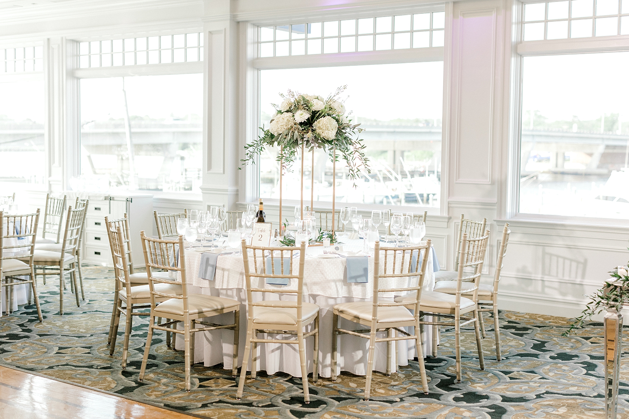 wedding reception at Crystal Point Yacht Club with gold and ivory details