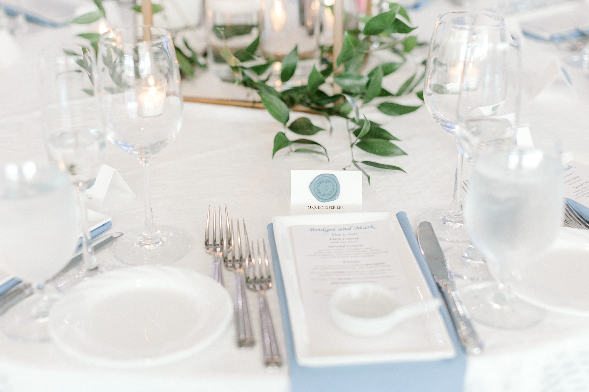 place setting with ivory and dusty blue napkins at Crystal Point Yacht Club