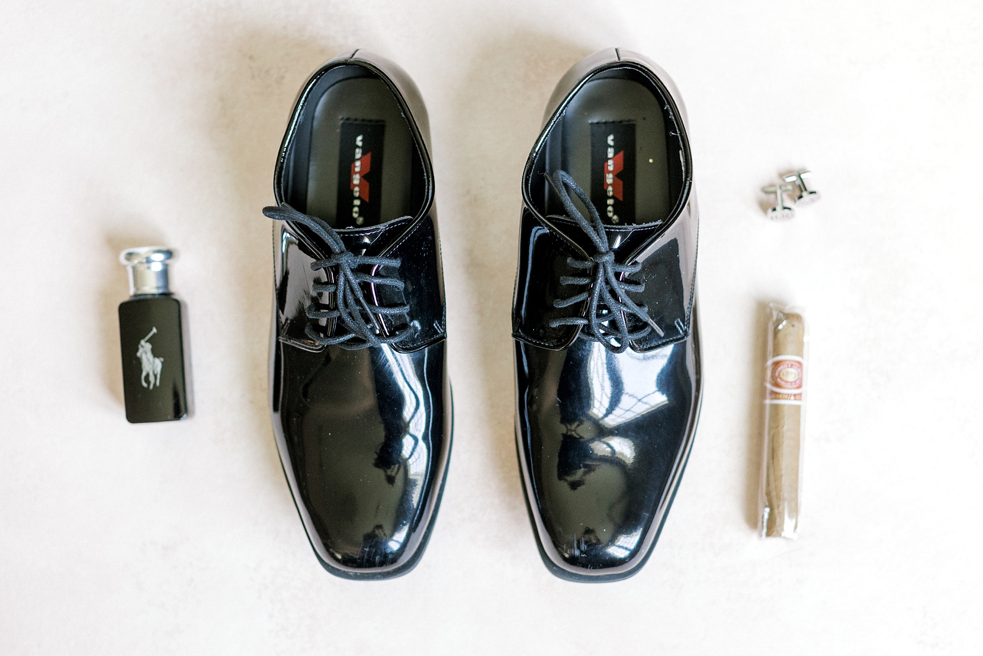 groom's shiny black shoes and cologne before NJ wedding