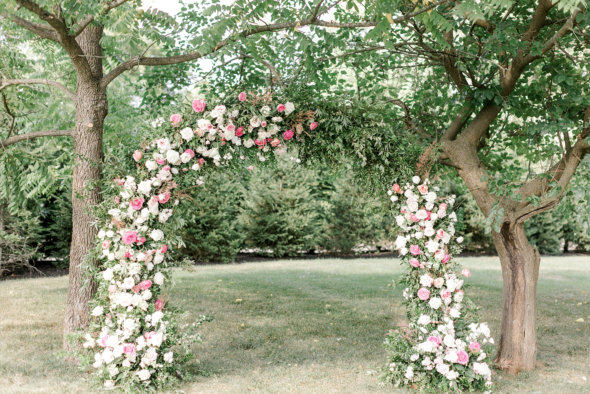 floral arch for ceremony on lawn at Ryland Inn
