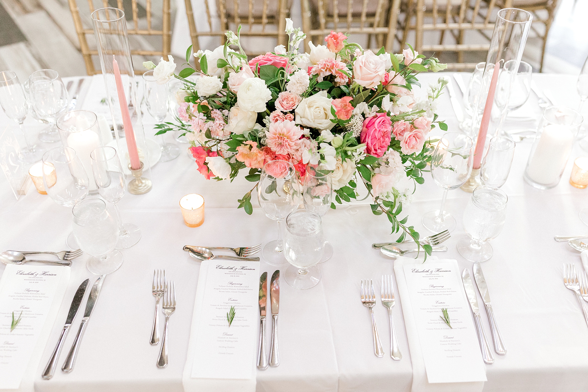 wedding reception table scape with pink and white flowers and pink taper candles