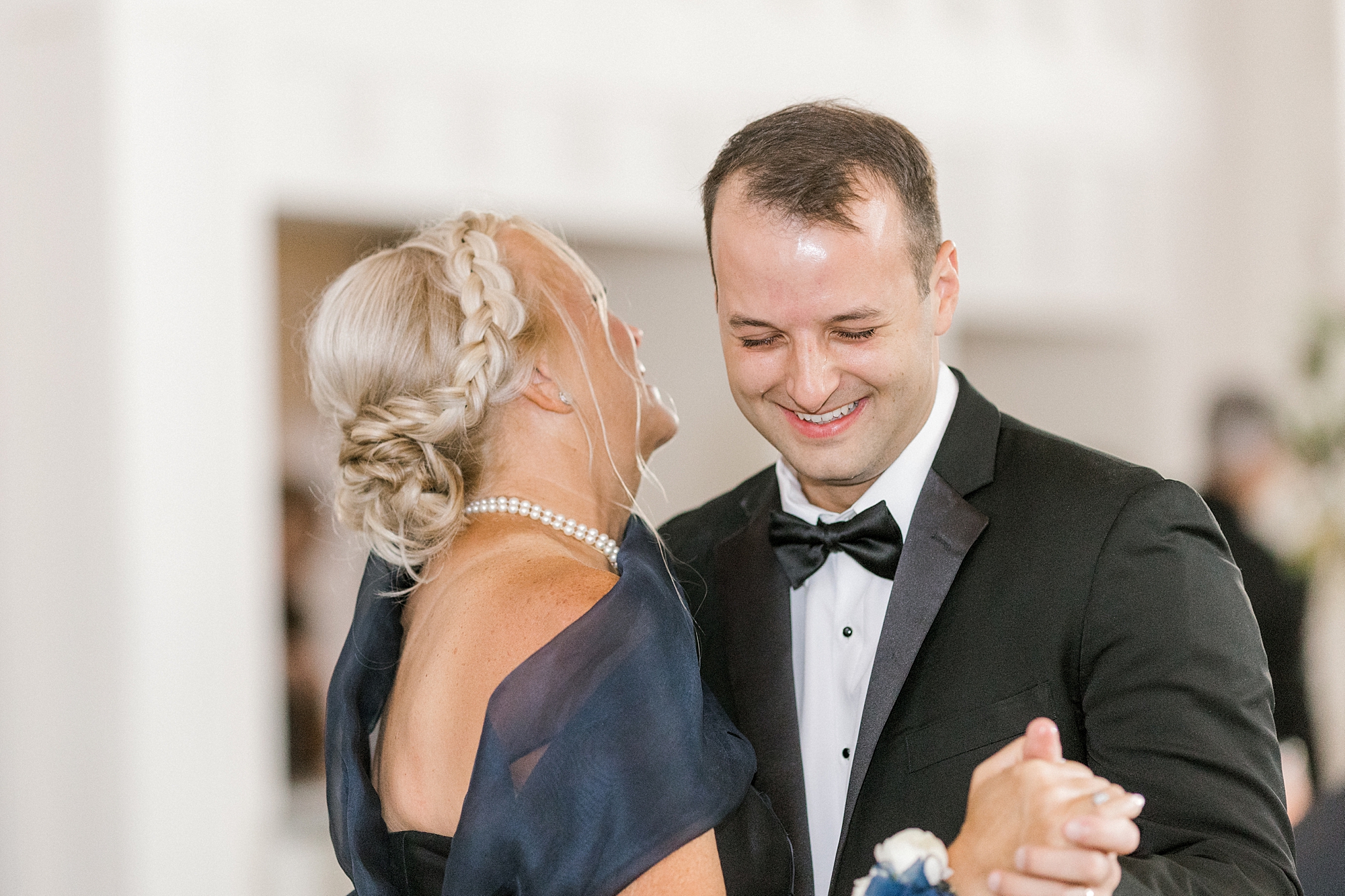 groom laughs with mother during dance at Whitehouse Station NJ wedding reception