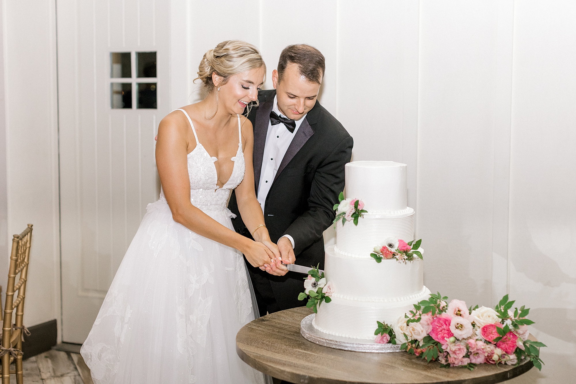 bride and groom cut wedding cake during Whitehouse Station NJ wedding reception