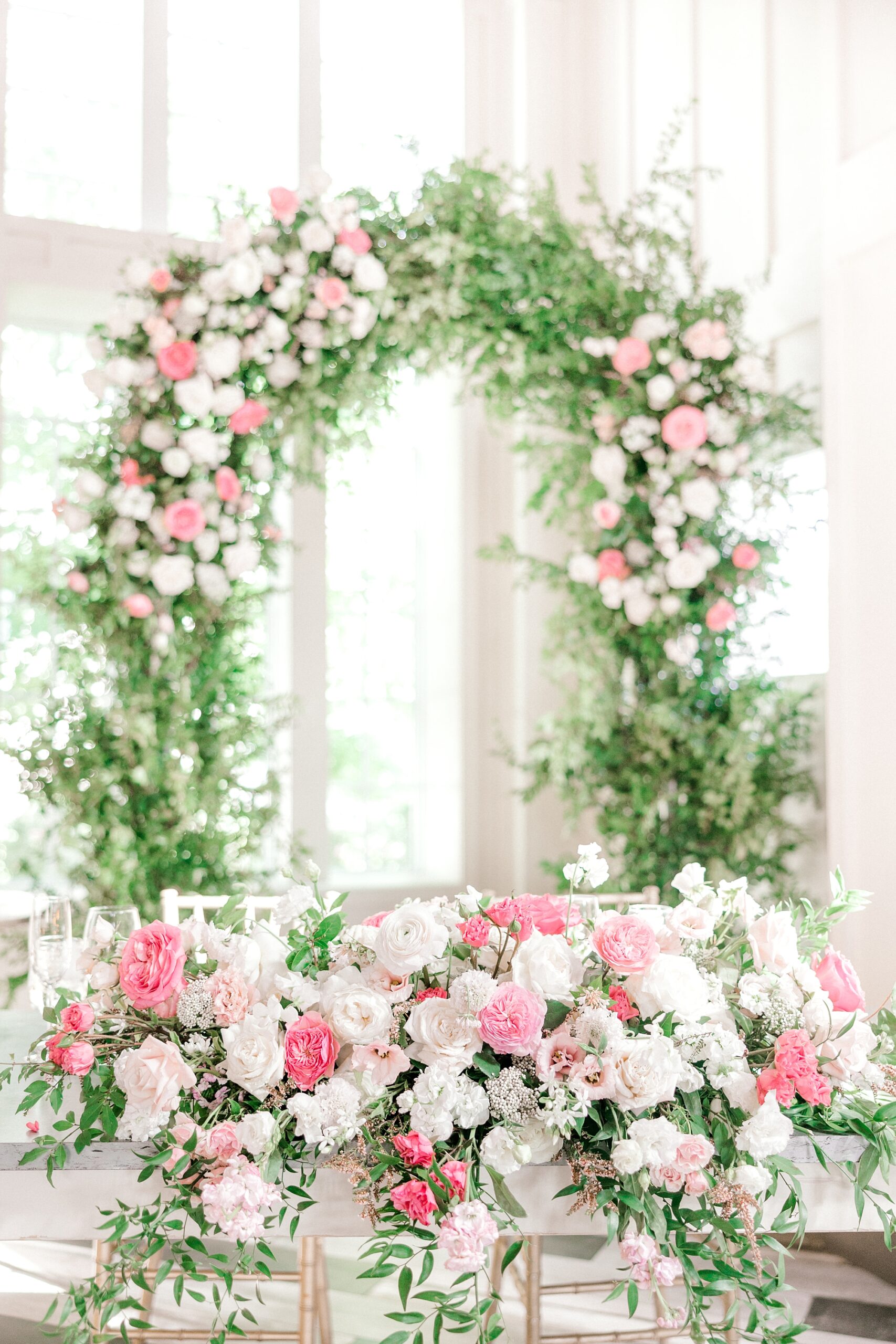 floral arch behind sweetheart table at Ryland Inn