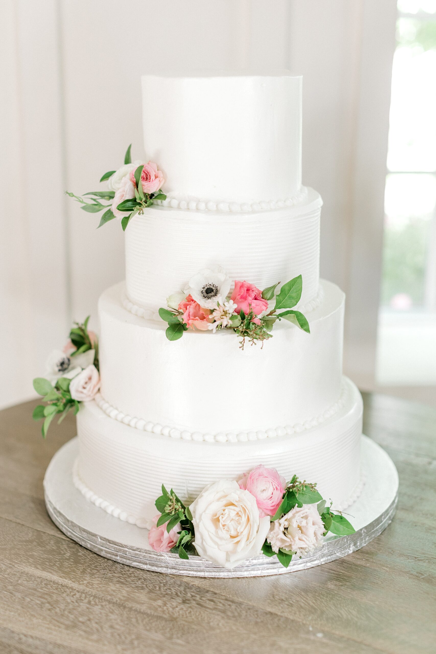 tiered wedding cake with floral accents at Ryland Inn