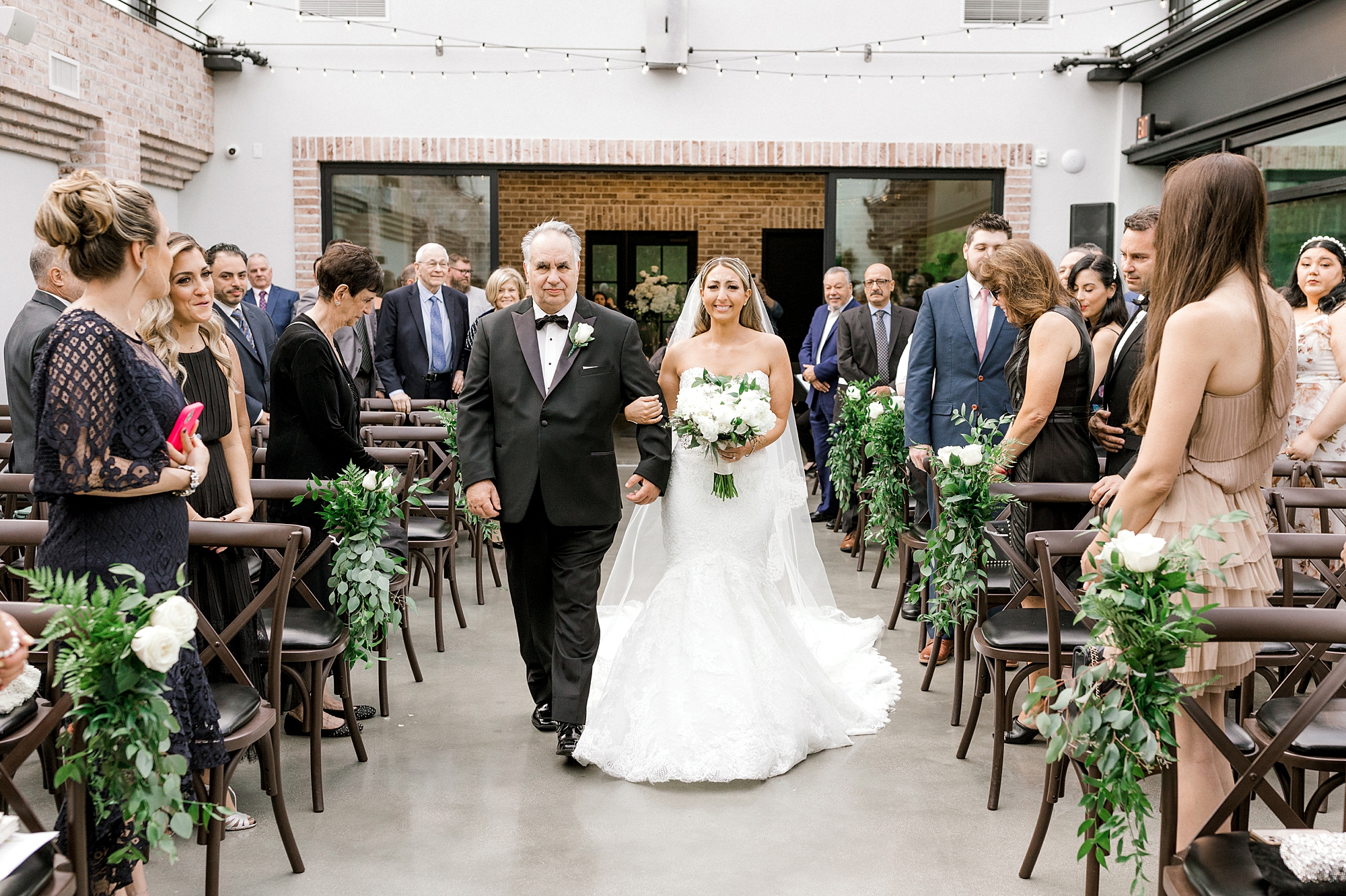 bride walks down aisle with father for ceremony at The Refinery at Perona Farms