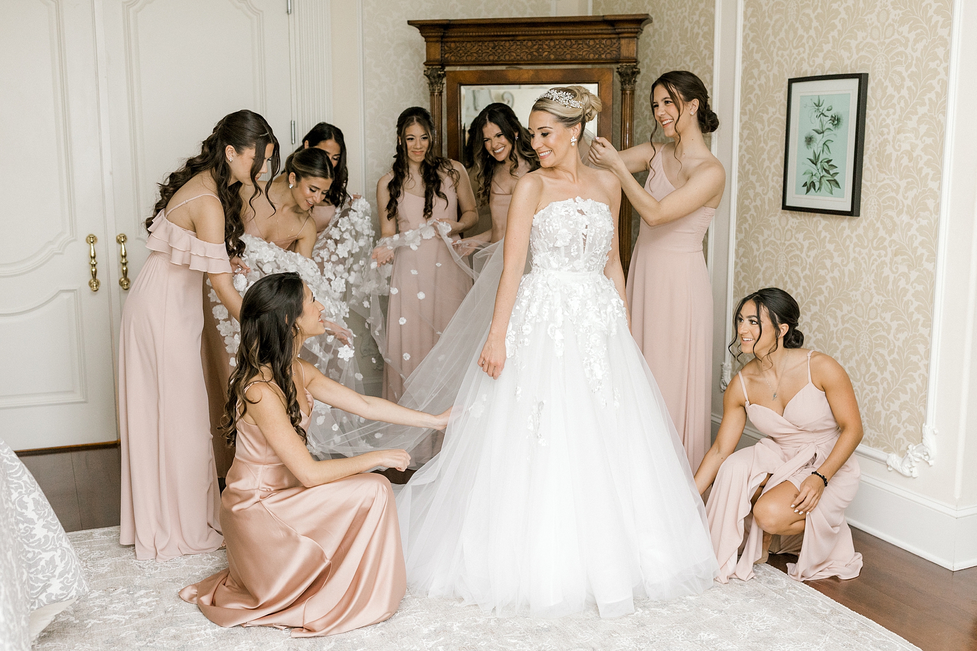 bridesmaids in pink gowns help bride with veil at the Ashford Estate