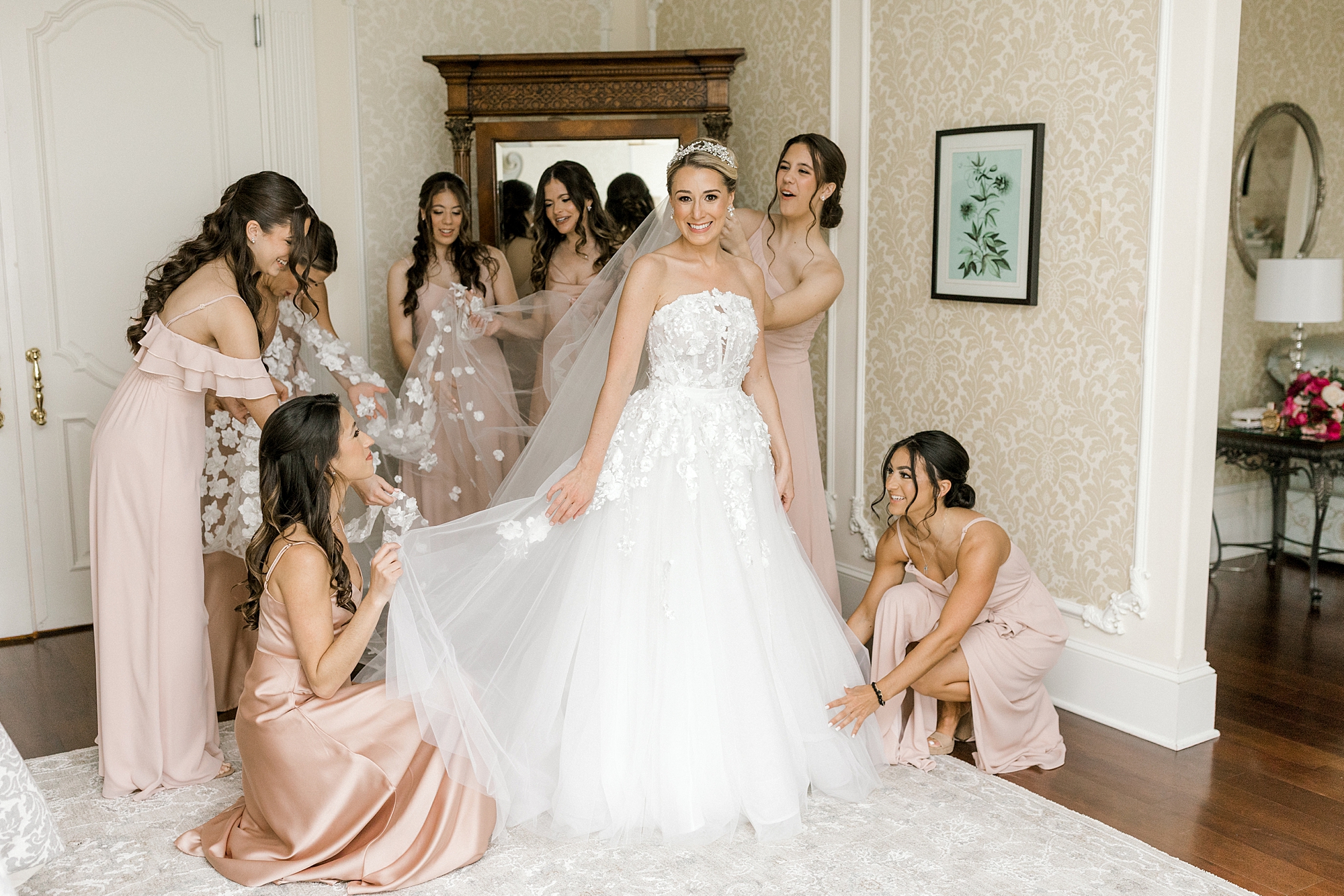 bridesmaids help bride with wedding dress at the Ashford Estate