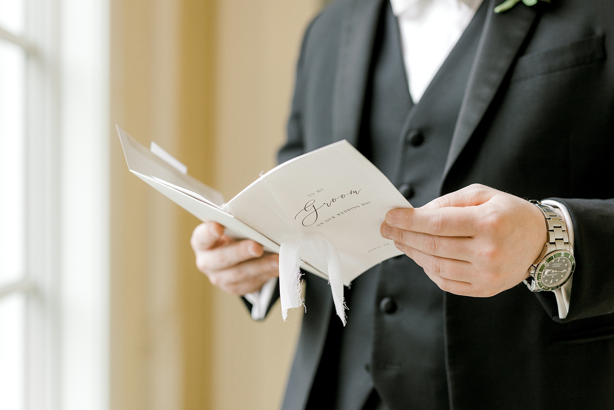 groom reads card from bride on morning of wedding