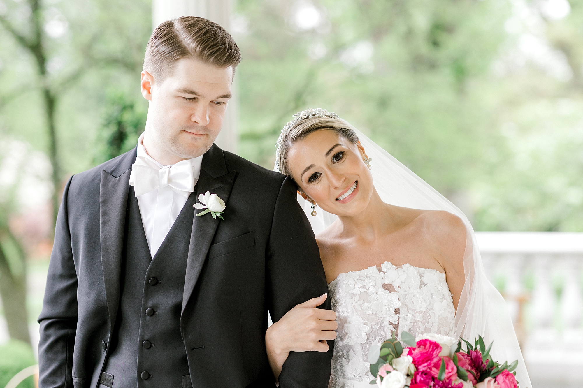 bride leans head on groom's shoulder during spring wedding photos