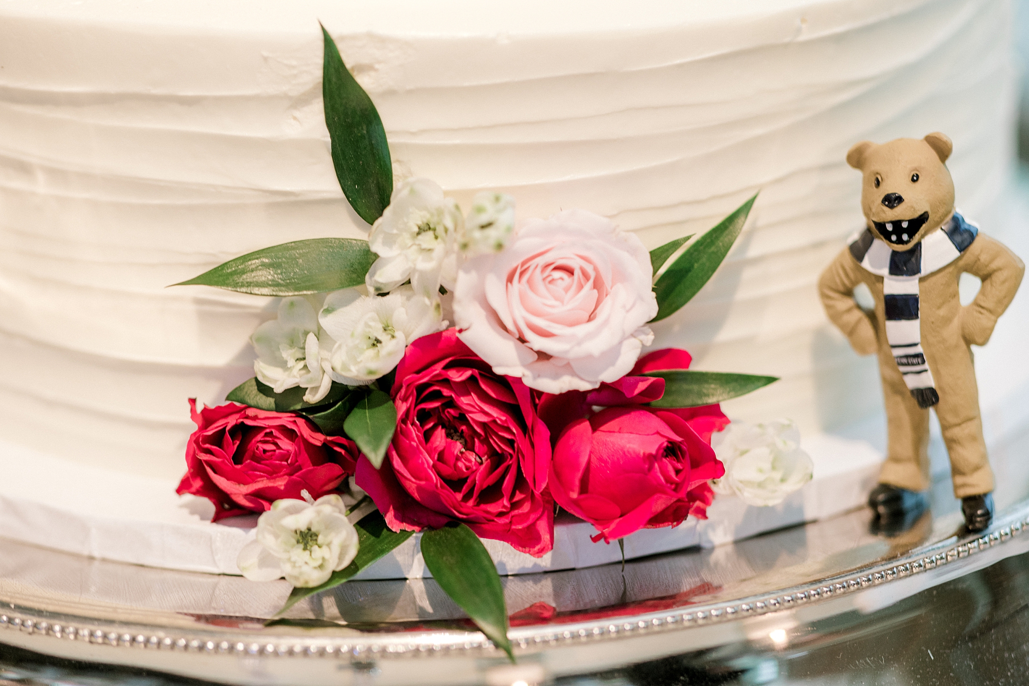 pink roses on wedding cake with white icing