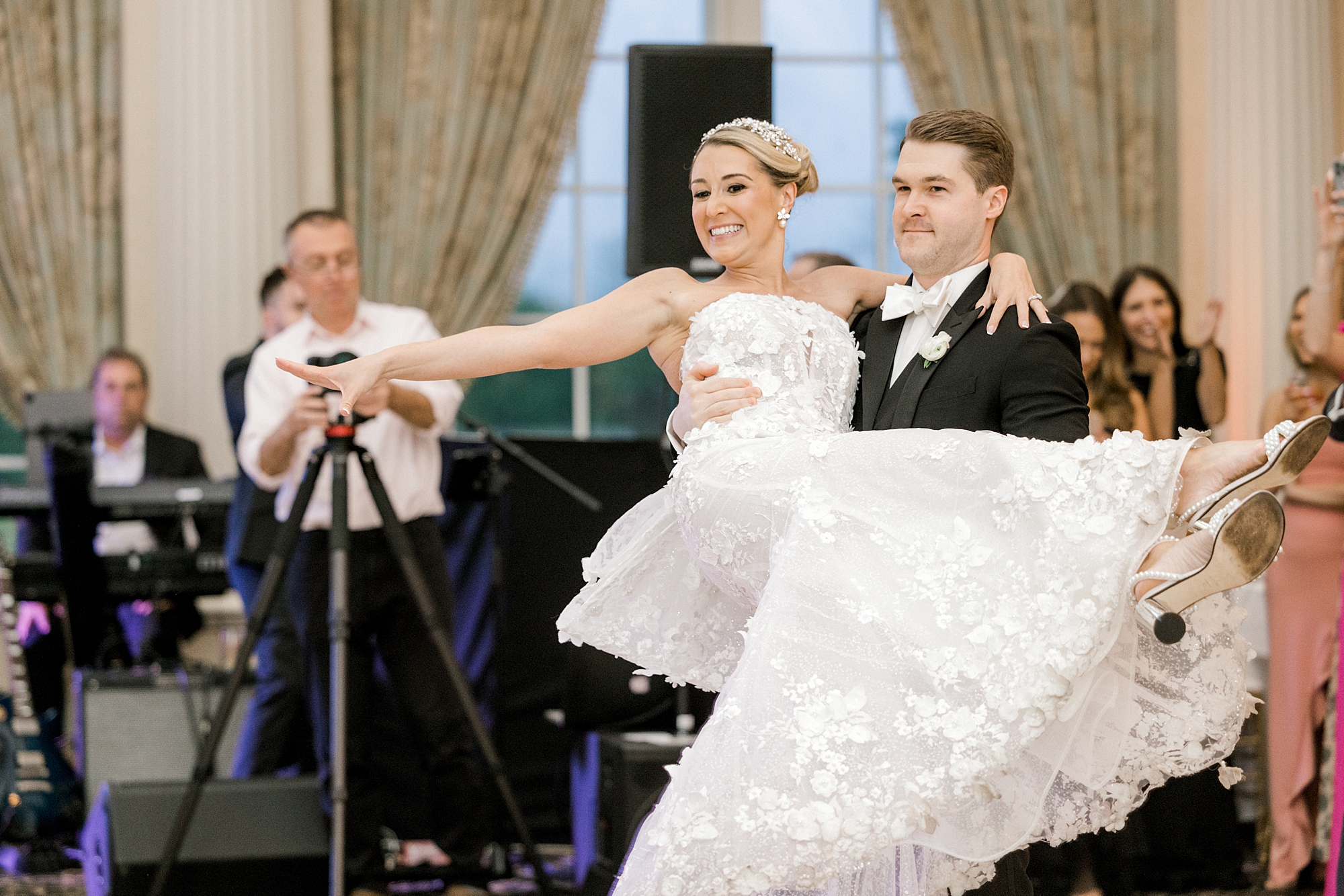 groom picks up bride and twirls her on dance floor at Allentown NJ wedding reception