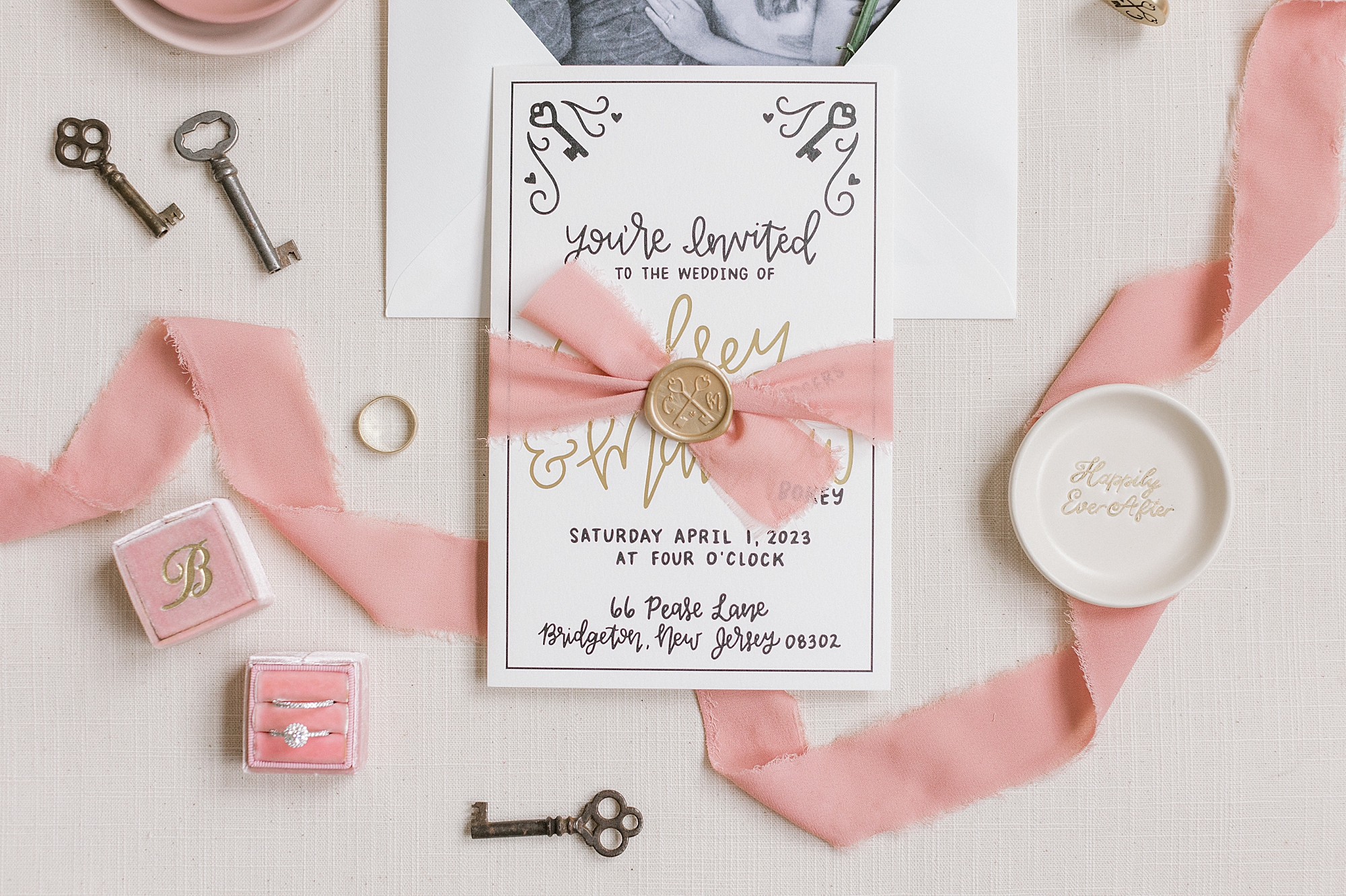 invitation suite with pink ribbon and gold wax seal