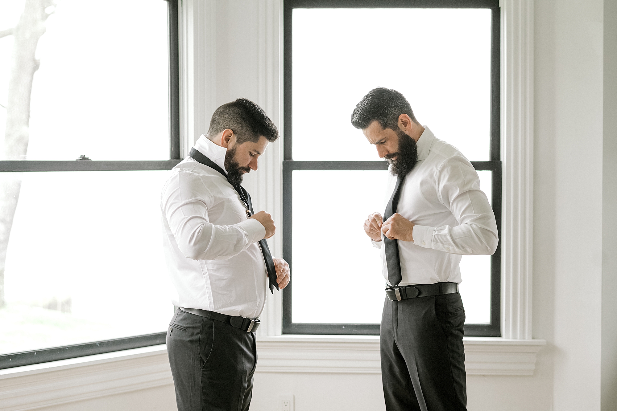 groom and best friend adjust black ties