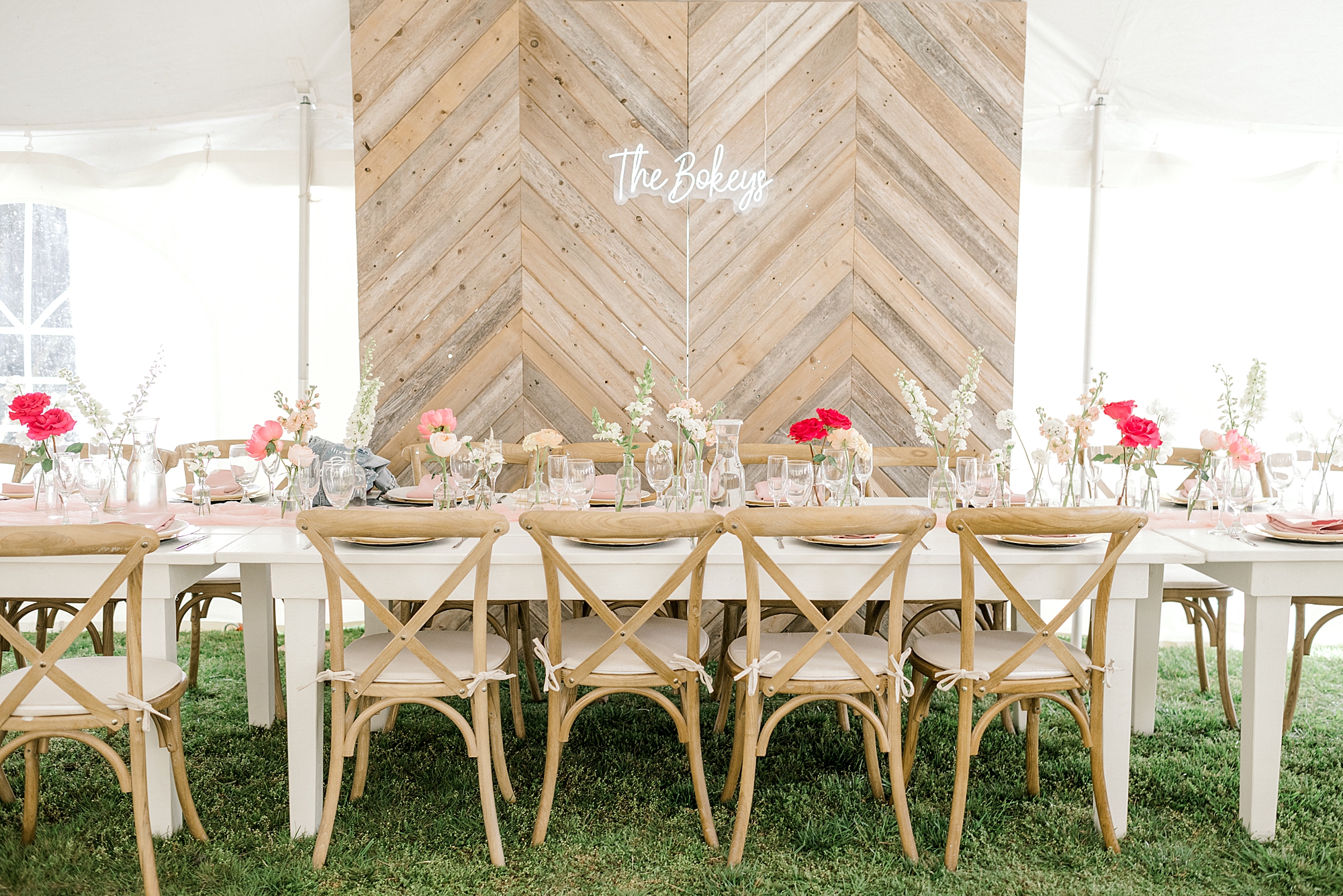 intimate wedding reception at The Townsend Property with wood wall and neon sign