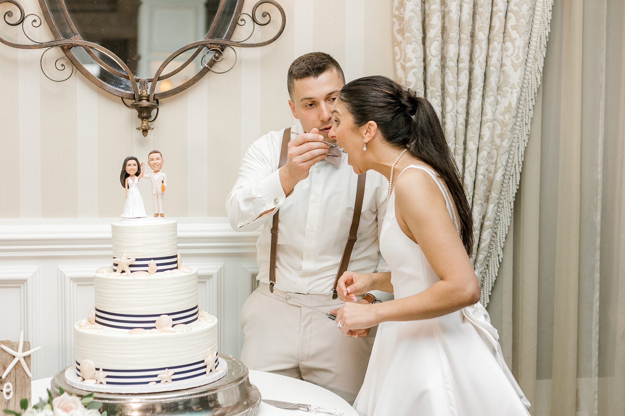 groom feeds bride cake during Manahawkin NJ wedding reception