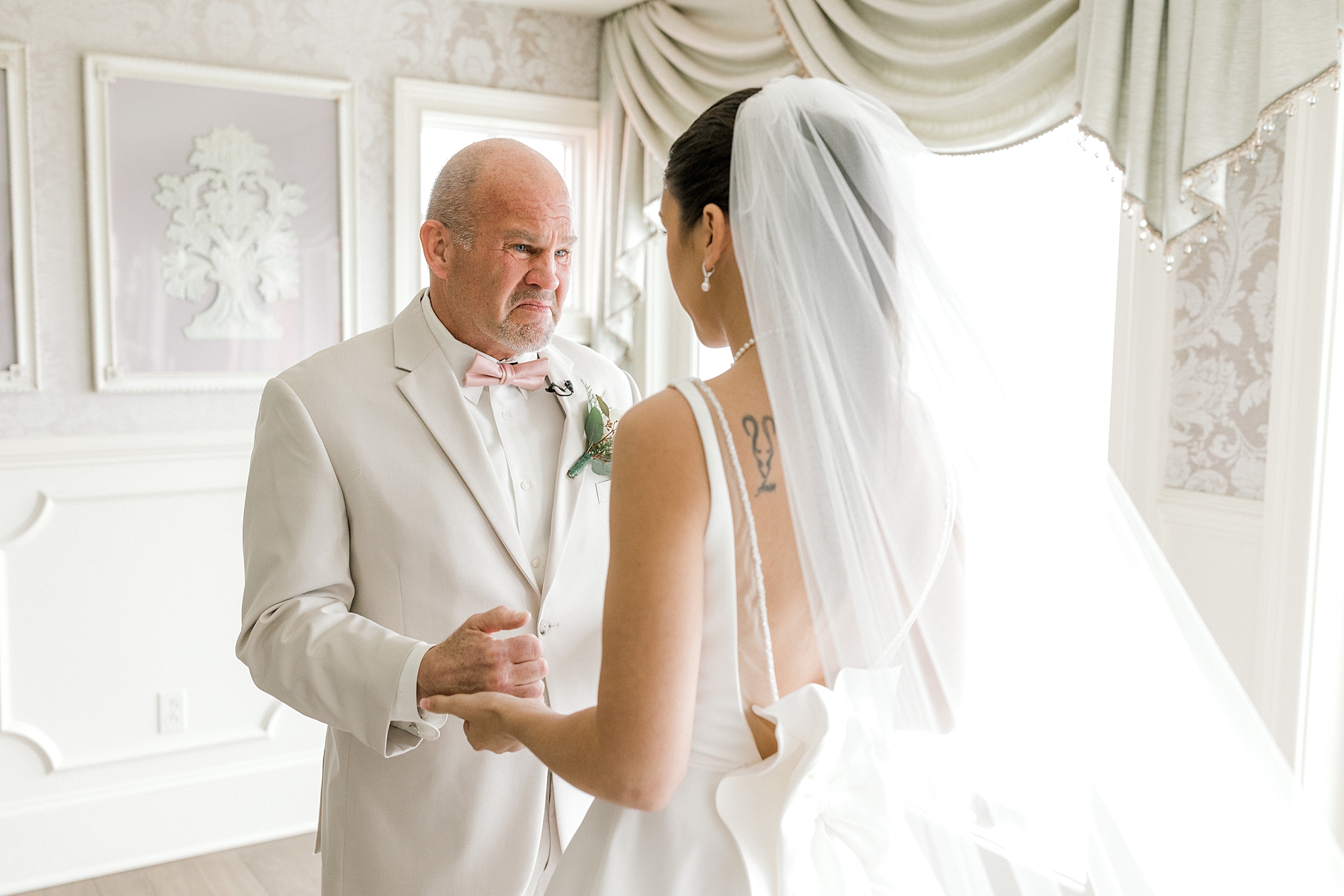 bride has first look with father in bridal suite at Mallard Island Yacht Club