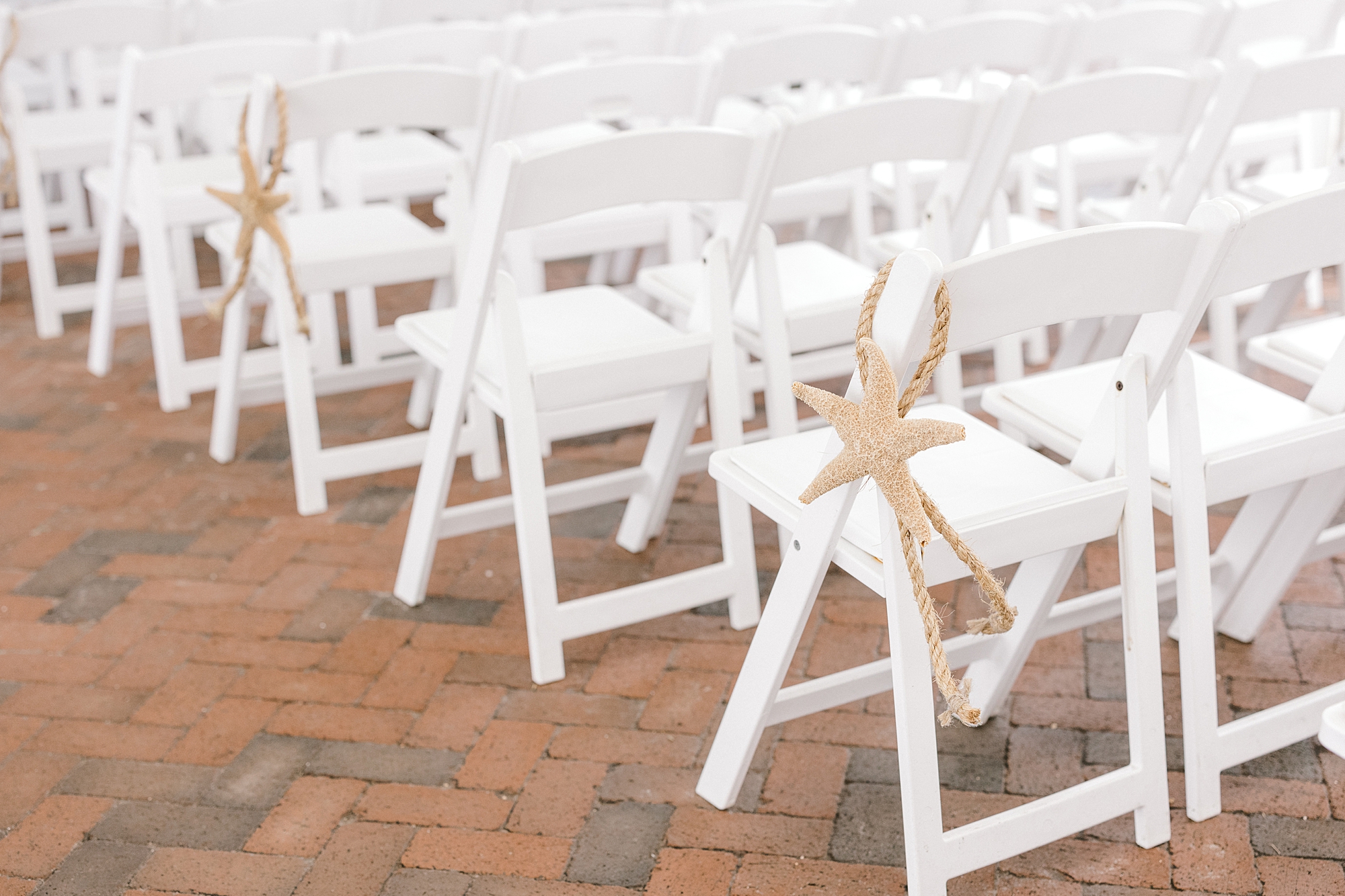 white folding chairs with starfish hanging on the side at Mallard Island Yacht Club