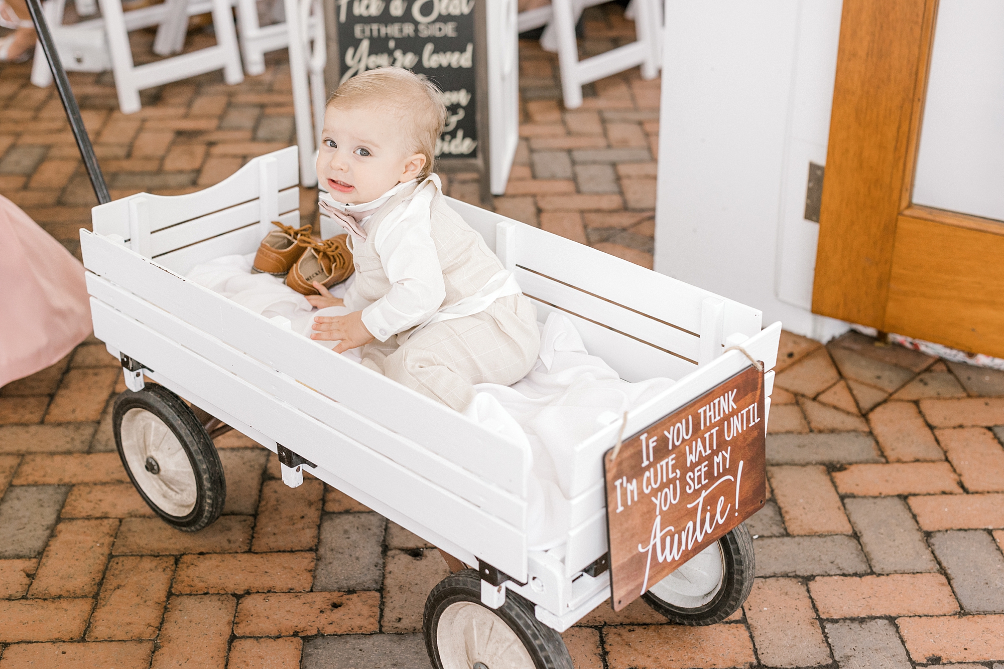 ring bearer rides in wagon for ceremony at Mallard Island Yacht Club