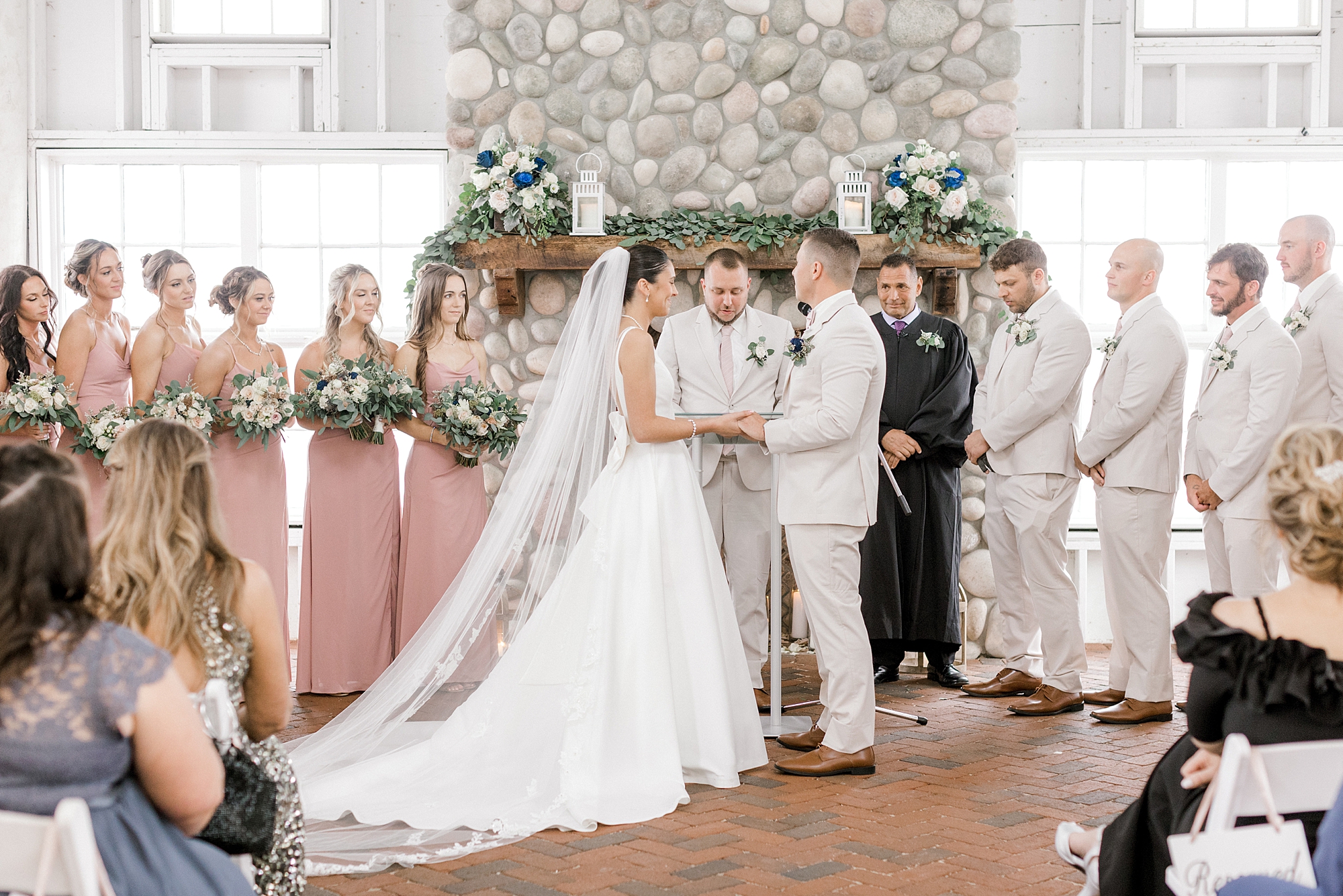 bride and groom hold hands during wedding ceremony at Mallard Island Yacht Club