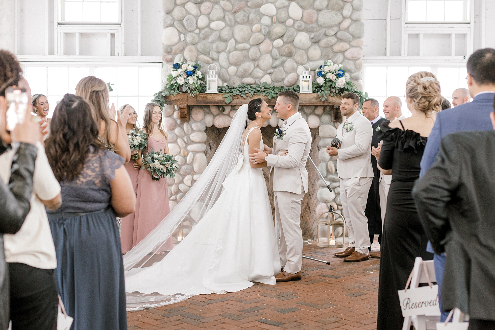 newlyweds kiss after wedding ceremony at Mallard Island Yacht Club