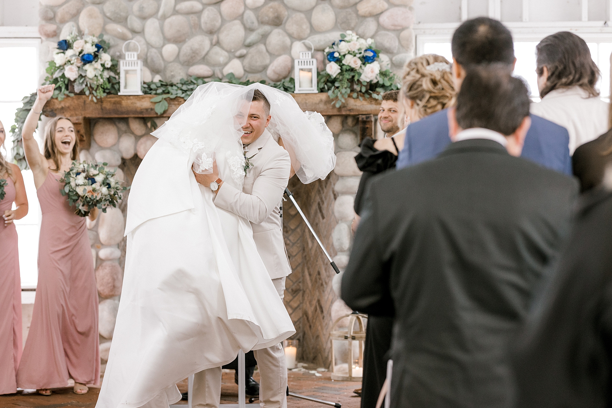 groom carries bride up the aisle over his shoulder at Mallard Island Yacht Club