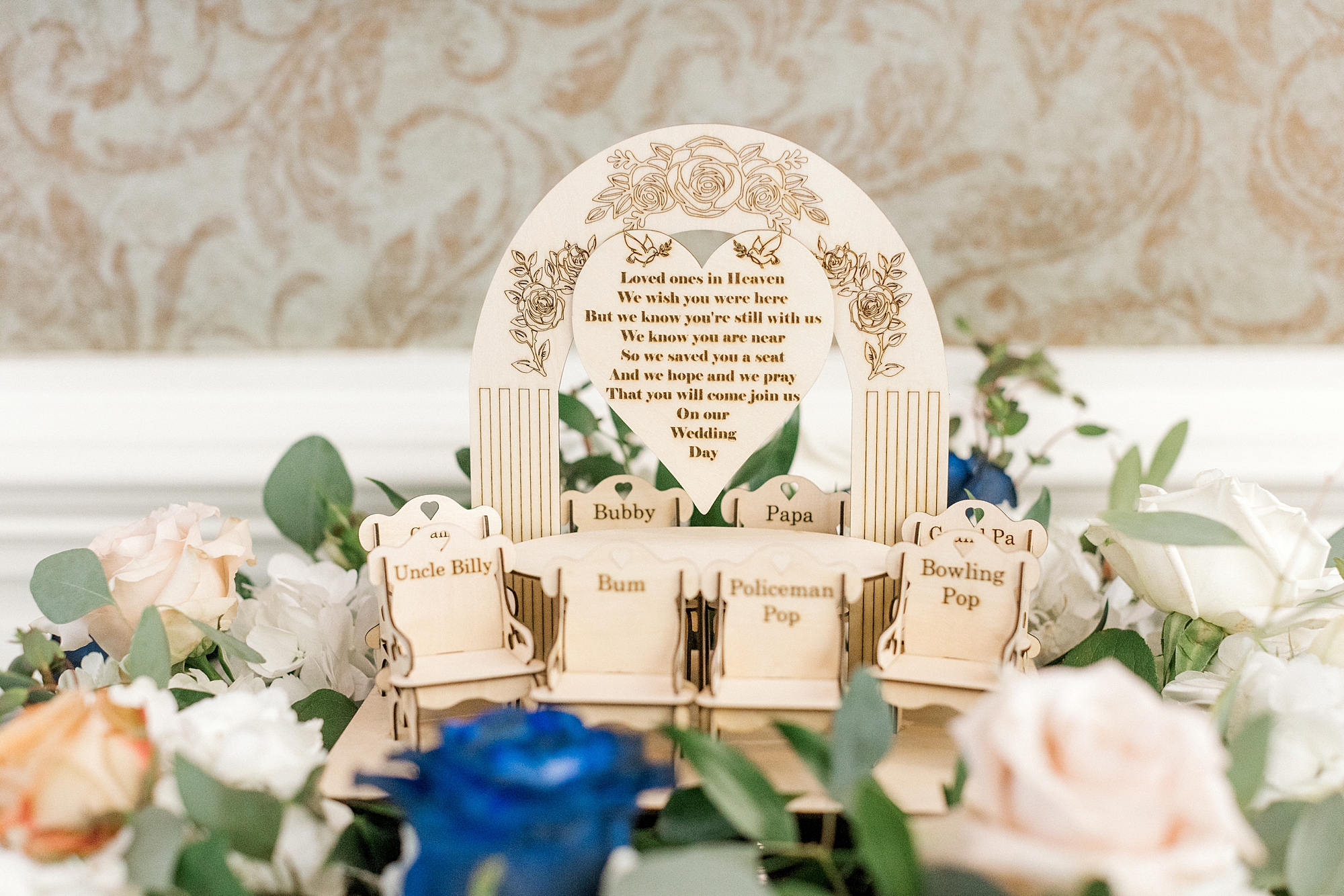 wooden signs for memory table tucked into blue and white flower arrangements