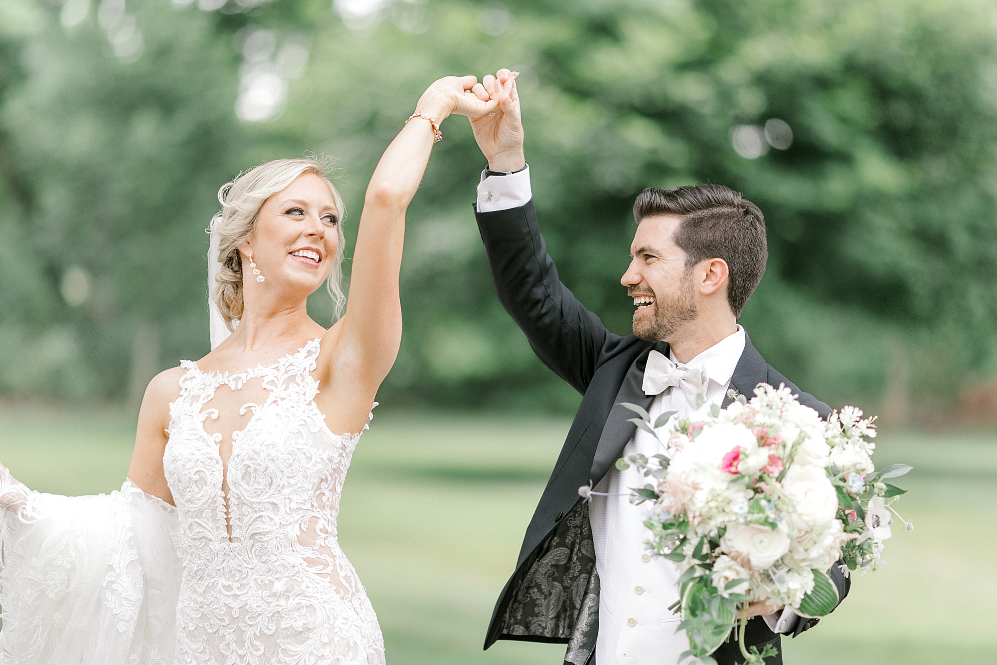 groom twirls bride on lawn at the Ashford Estate