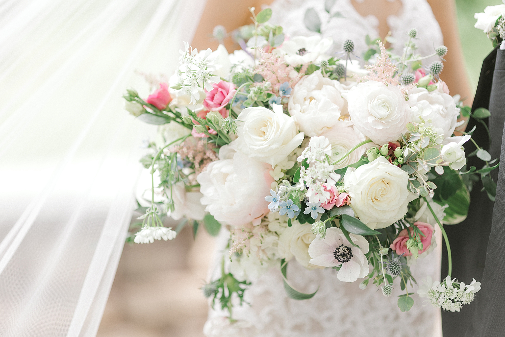 bride holds bouquet of white and pink flowers at the Ashford Estate