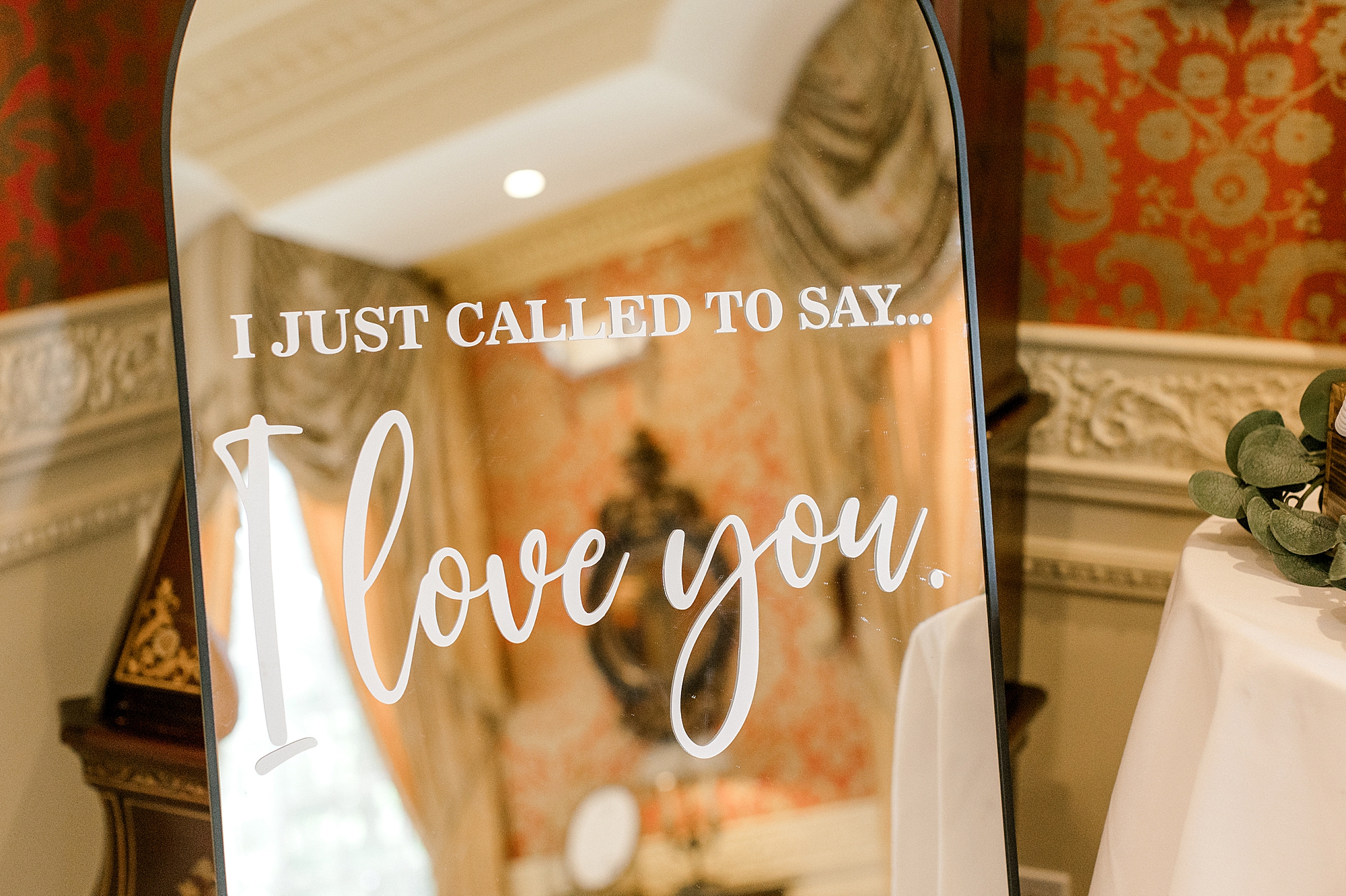 mirror with gold frame that says "I just called to say... I love you"