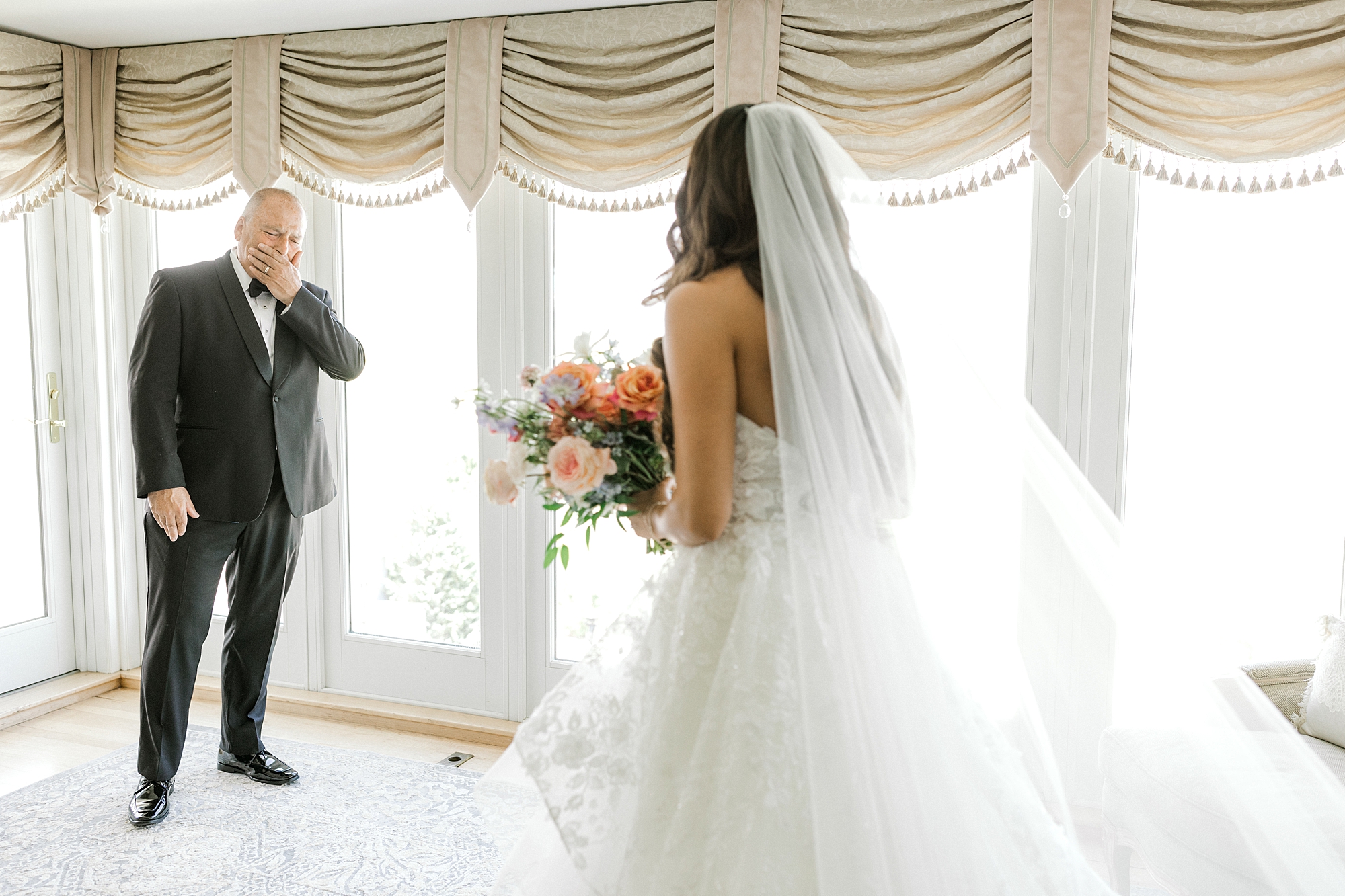 father covers mouth crying during first look with bride at Bonnet Island Estate
