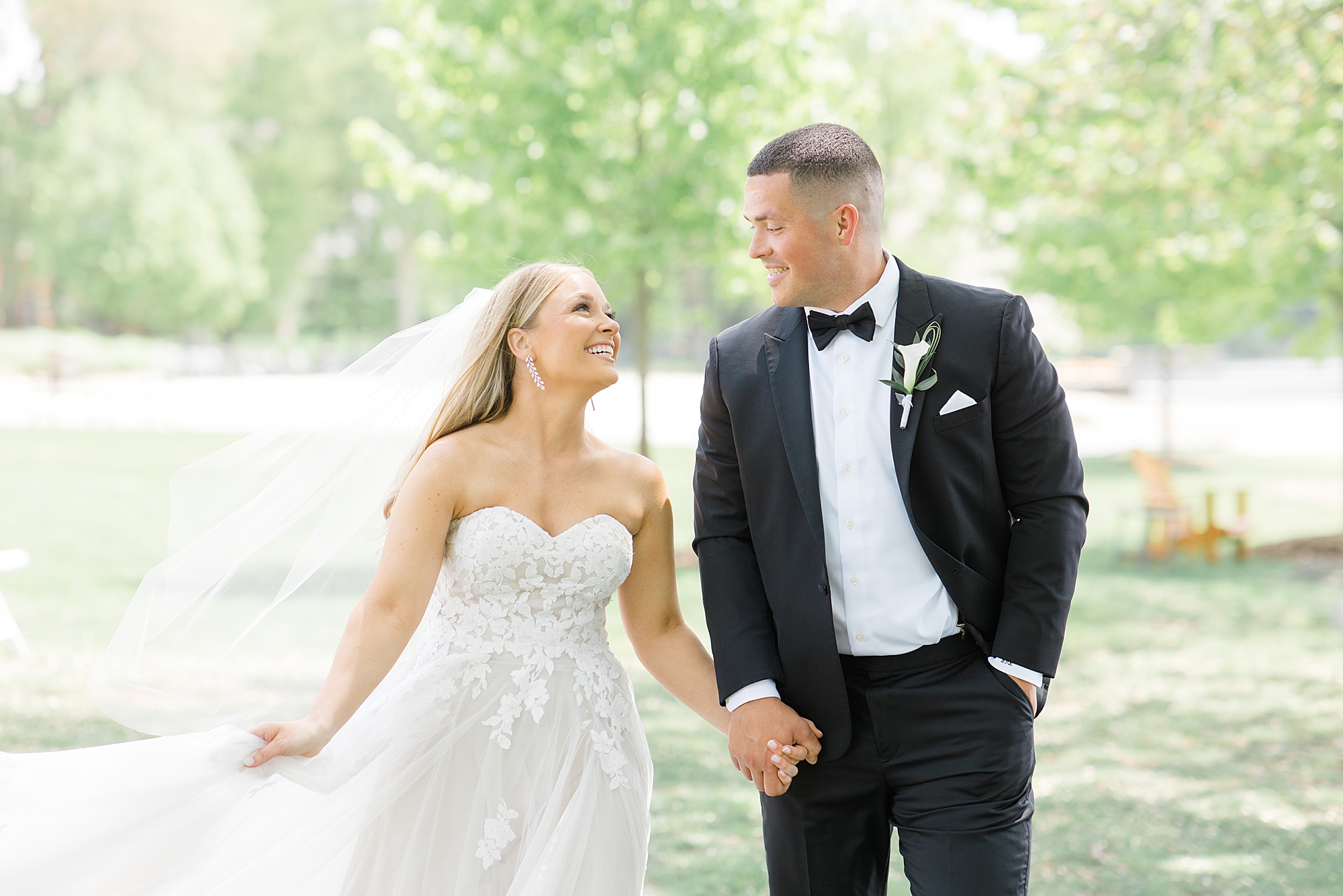 newlyweds hold hands walking together and smiling in New Jersey