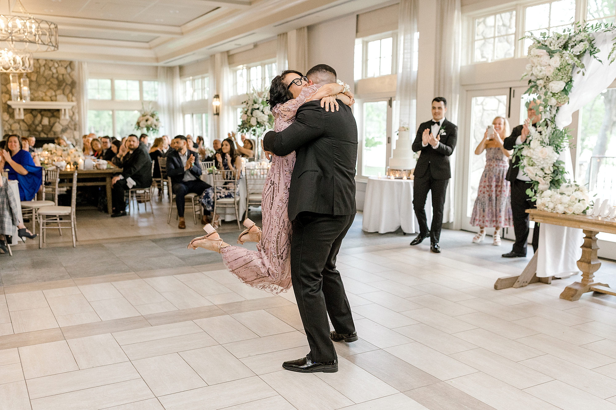 groom lifts mom off the ground during NJ wedding reception