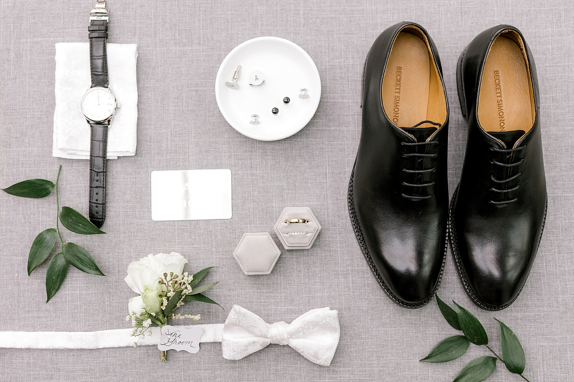 groom's black shoes, white bow tie, watch and details