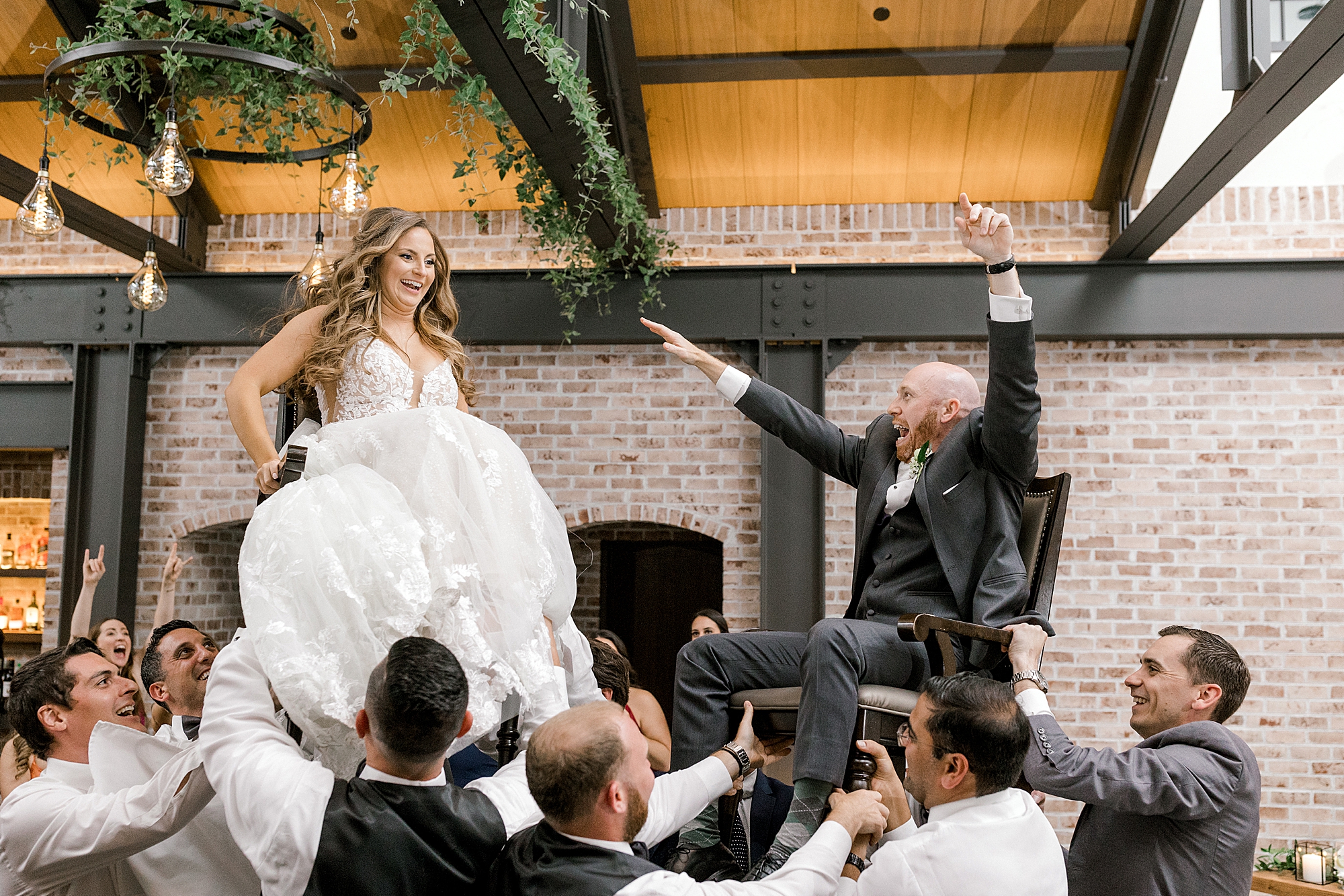 guests lift up bride and groom during Hora